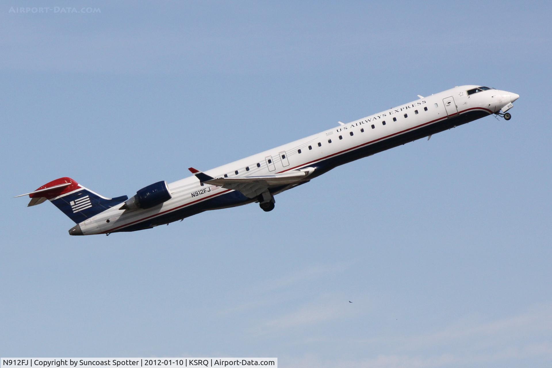 N912FJ, 2004 Bombardier CRJ-900ER (CL-600-2D24) C/N 15012, Mesa Airlines/US Airways Express Flight 2647 departs from Runway 14 at Sarasota-Bradenton International Airport enroute to Charlotte/Douglas International Airport