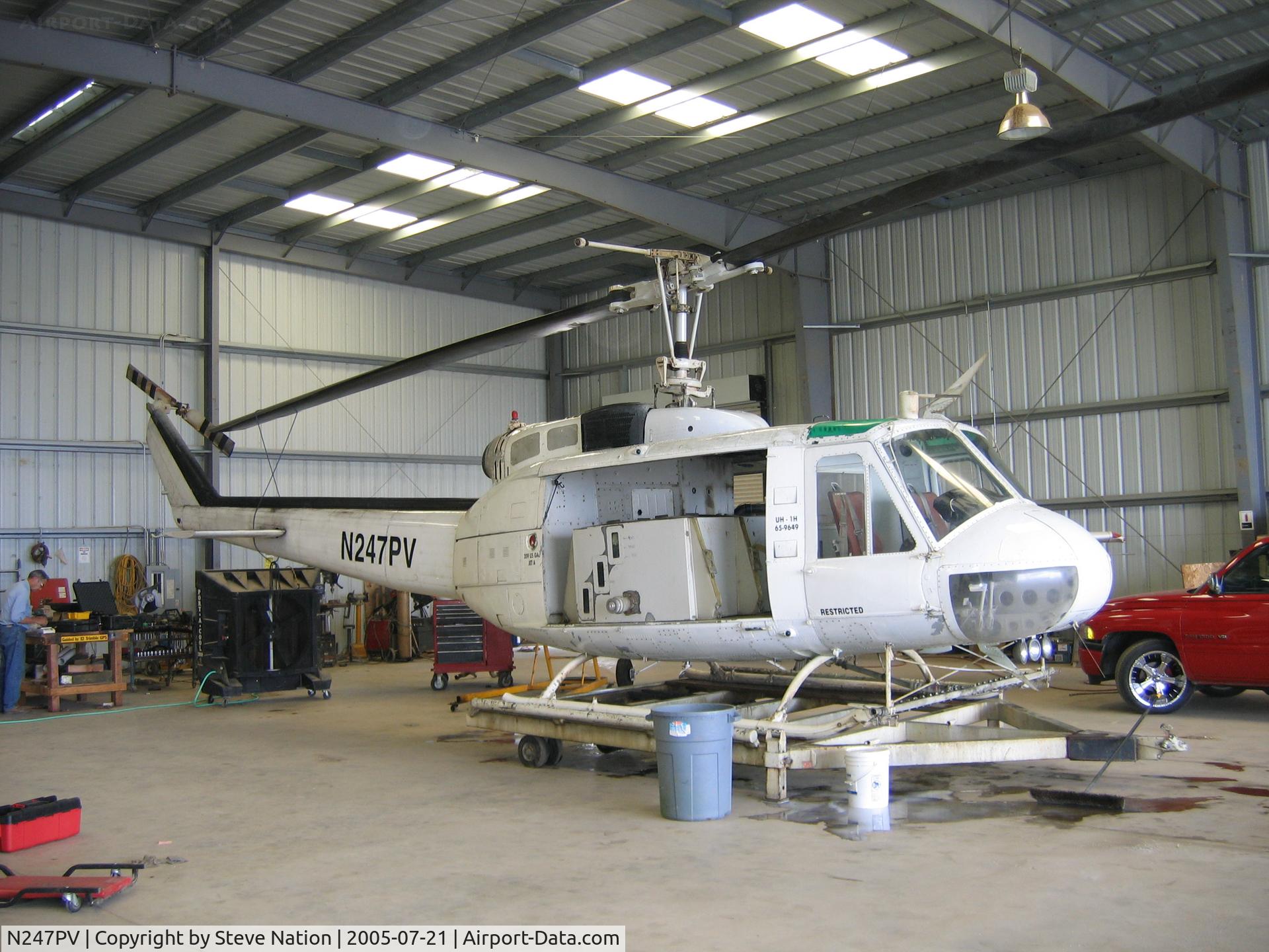 N247PV, 1965 Bell UH-1D Iroquois C/N 4693, Pacific Valley Aviation Williams Helicopter/Bell UH-1H (65-9649) sprayer at PVA facility near Arbuckle, CA