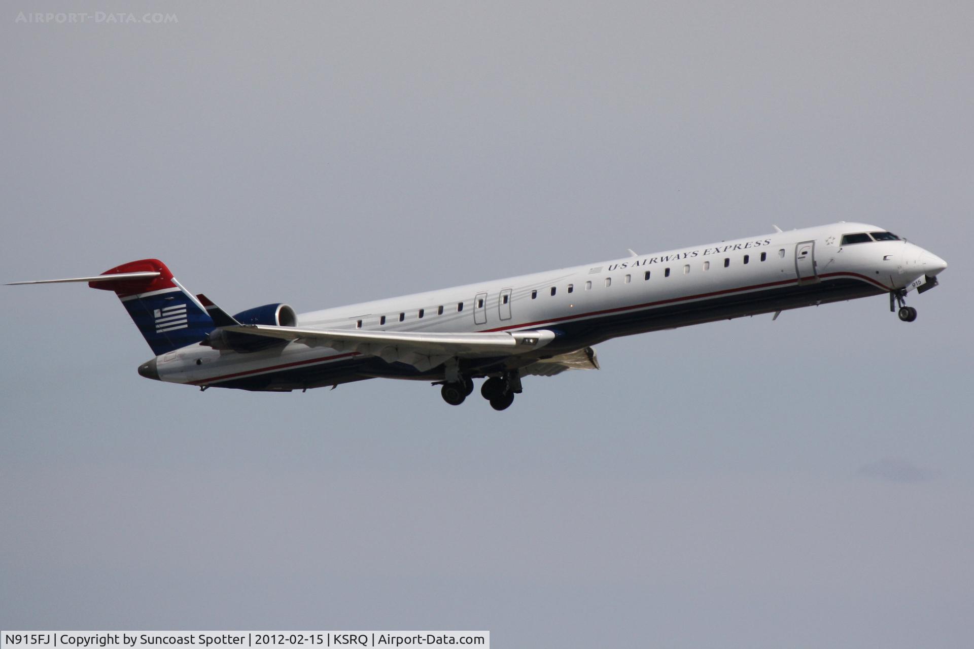 N915FJ, 2004 Bombardier CRJ900 (CL-600-2D24) C/N 15015, Mesa/US Airlines Flight 2647 departs Runway 14 at Sarasota-Bradenton International Airport enroute to Sarasota-Bradenton International Airport