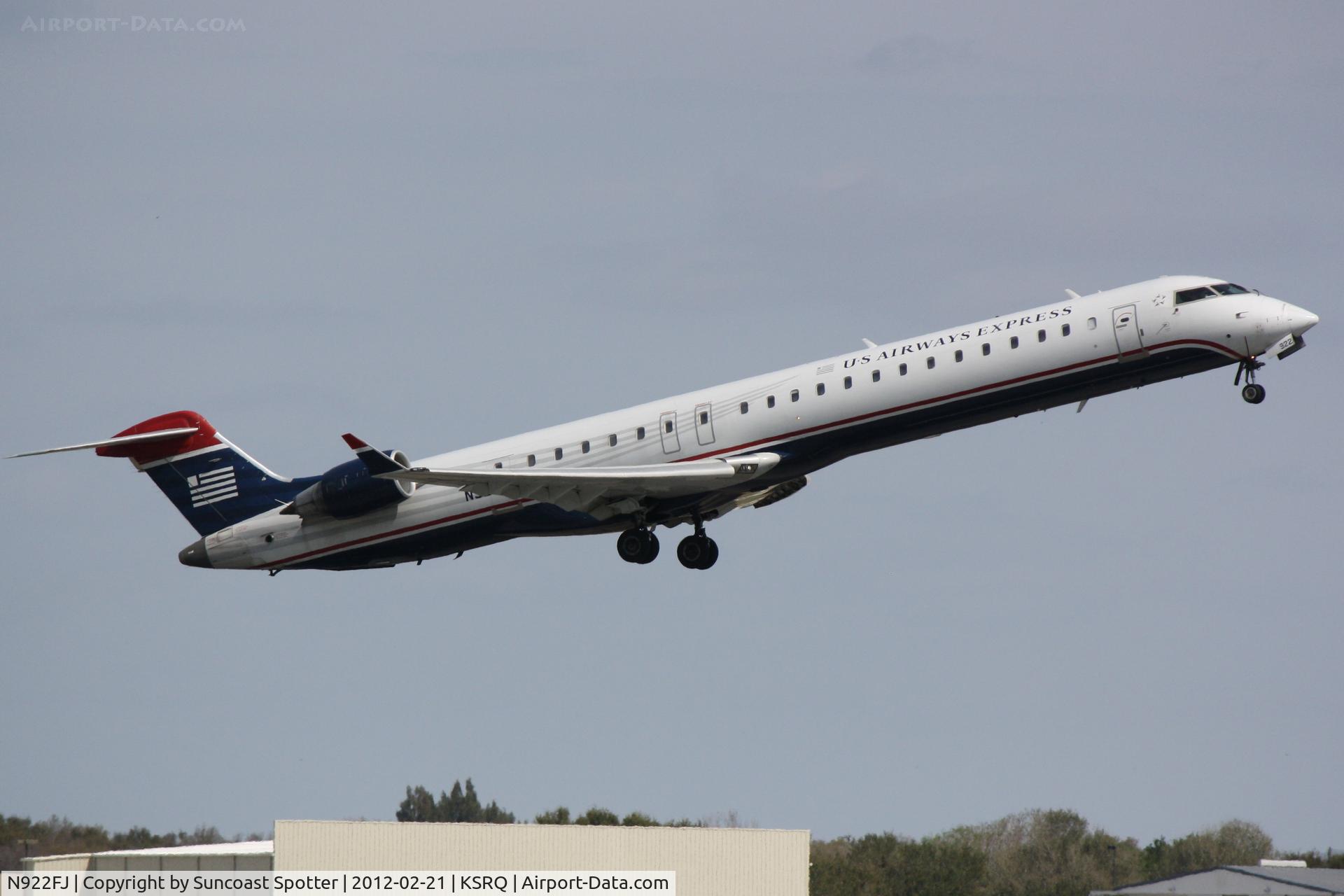 N922FJ, 2004 Bombardier CRJ-900ER (CL-600-2D24) C/N 15022, Mesa/US Air Flight 2647 departs Runway 14 at Sarasota-Bradenton International Airport enroute to Charlotte/Douglas International Airport