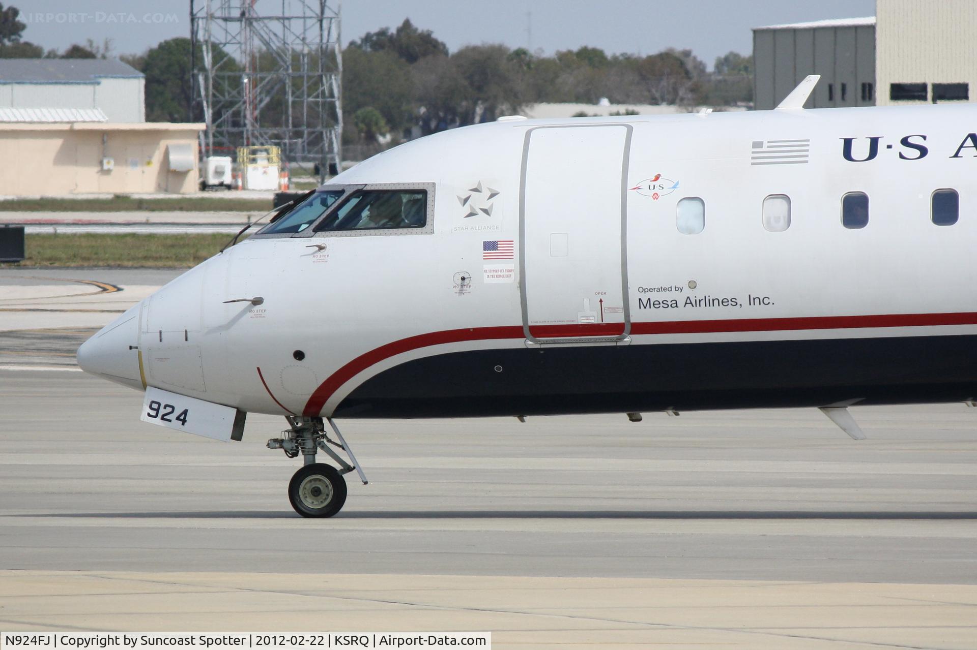 N924FJ, 2004 Bombardier CRJ-900ER (CL-600-2D24) C/N 15024, Mesa/US Flight 2607 arrives on Runway 14 at Sarasota-Bradenton International Airport following a flight from Charlotte/Douglas International Airport