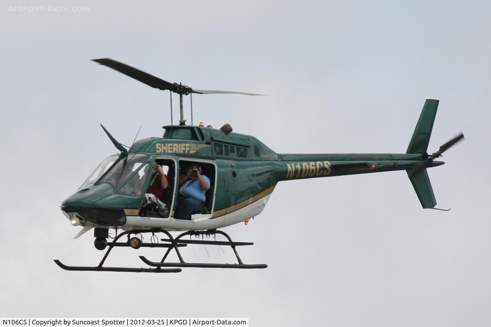 N106CS, Bell OH-58C Kiowa C/N 40713 (70-15162), Charlotte County Sheriff's OH-58 flies over the crowd at the Florida International Air Show