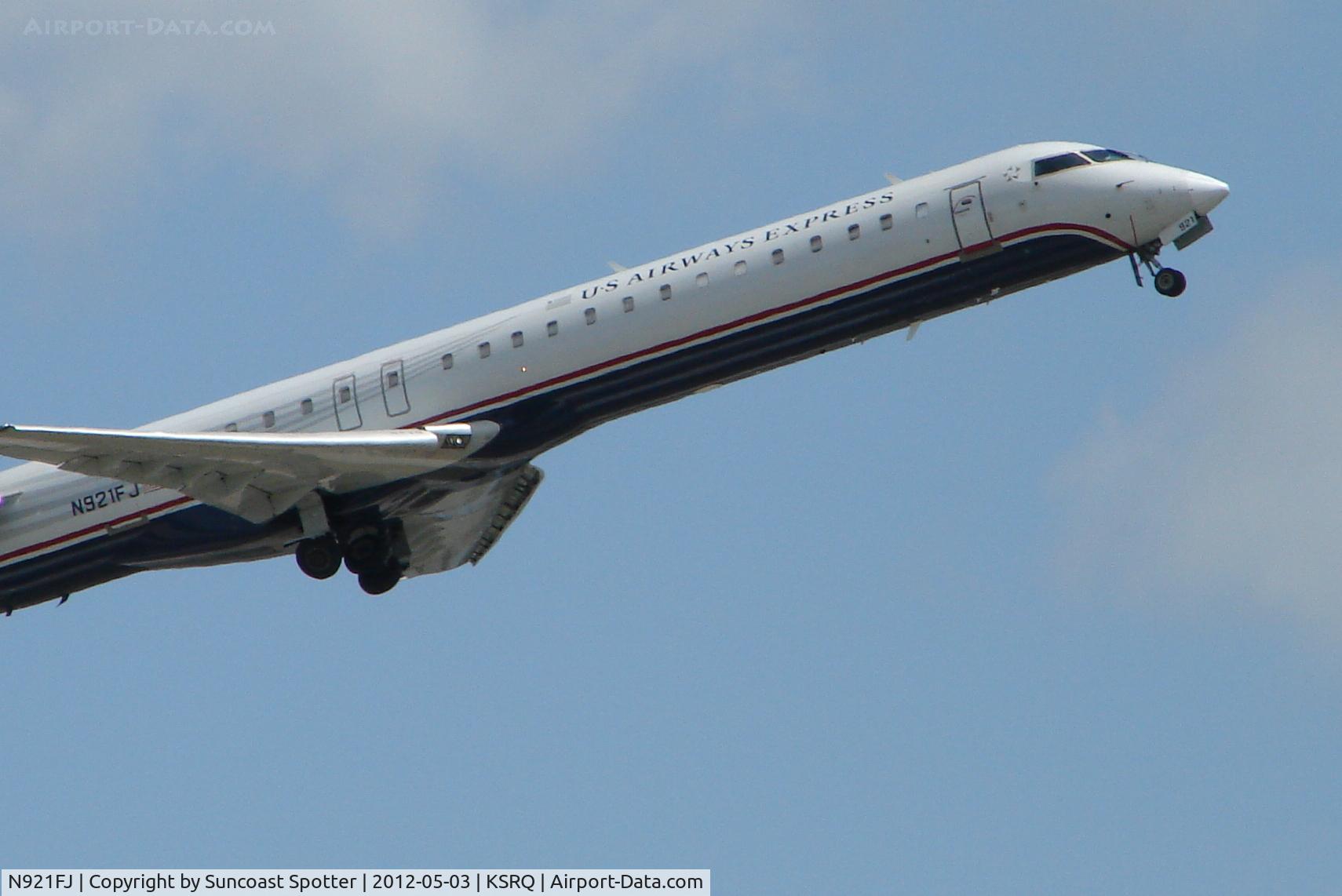 N921FJ, 2004 Bombardier CRJ-900ER (CL-600-2D24) C/N 15021, Mesa/US Air Flight 2662 departs Runway 14 at Sarasota-Bradenton International Airport enroute to Charlotte-Douglas International Airport