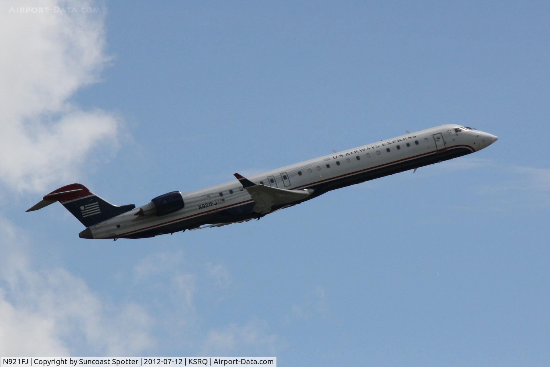 N921FJ, 2004 Bombardier CRJ-900ER (CL-600-2D24) C/N 15021, US Air Flight 2709 operated by Mesa departs Sarasota-Bradenton International Airport enroute to Charlotte-Douglas International Airport