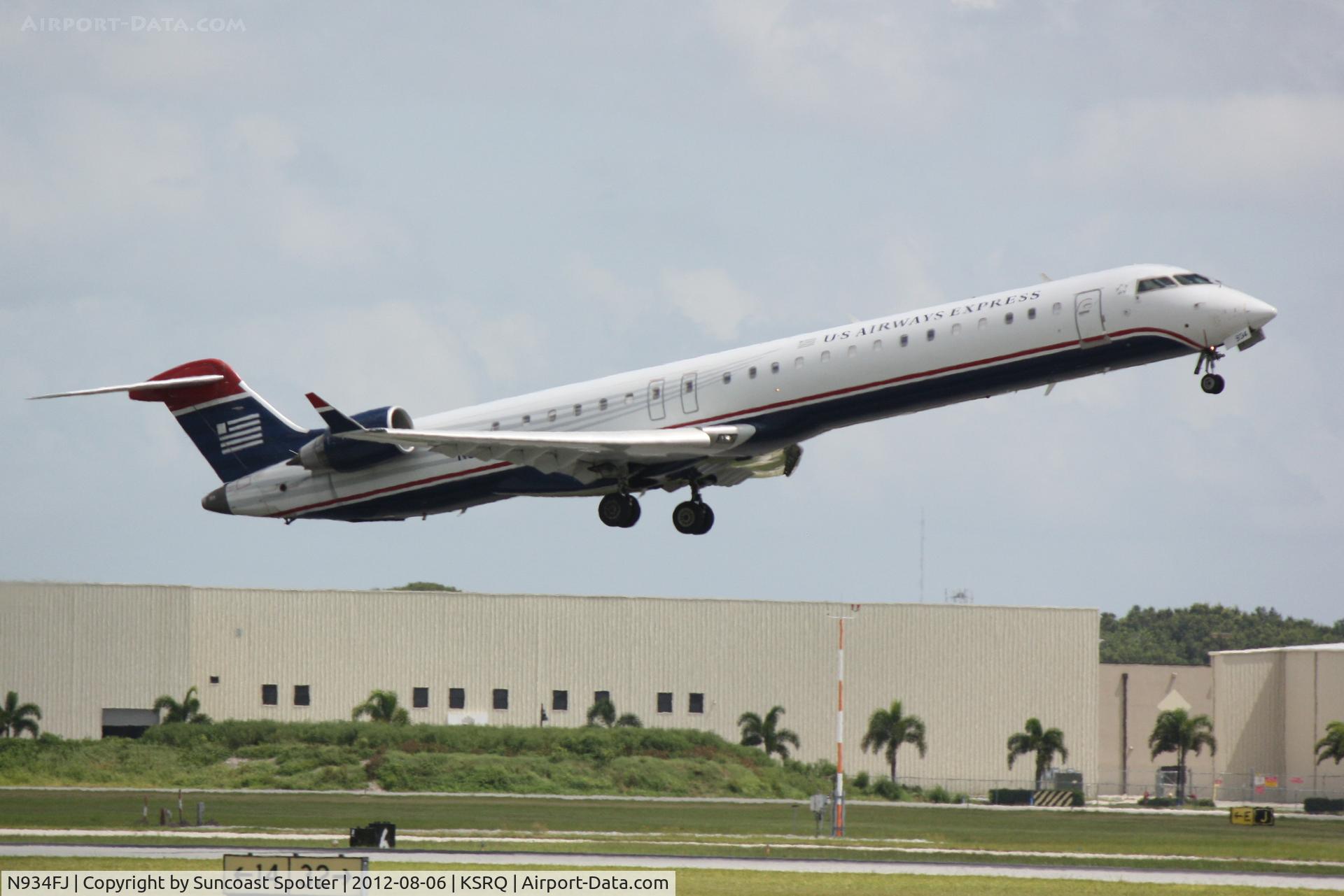 N934FJ, 2005 Bombardier CRJ-900ER (CL-600-2D24) C/N 15034, US Air Flight 2709 operated by Mesa departs Sarasota-Bradenton International Airport enroute to Charlotte-Douglas International Airport