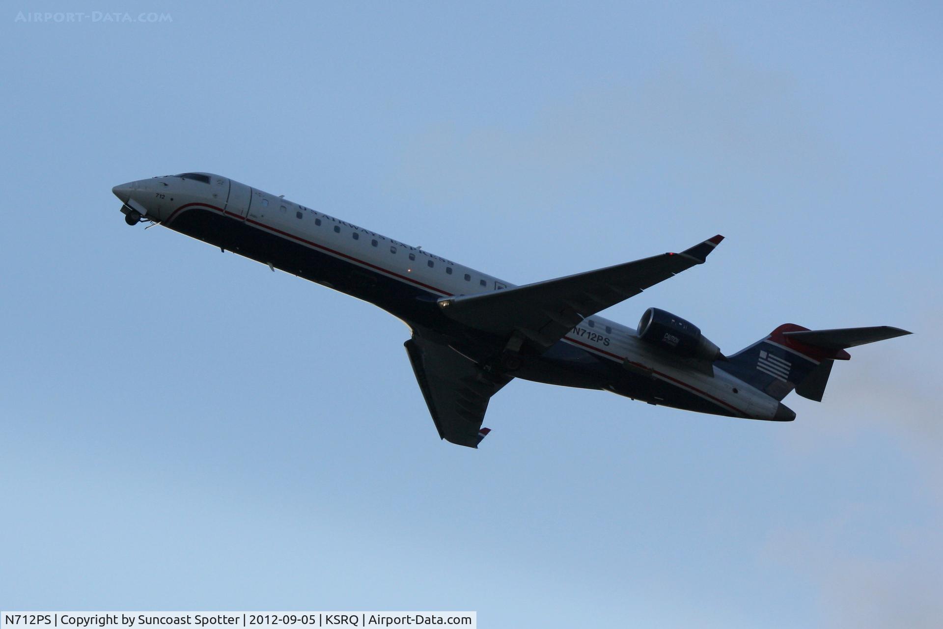 N712PS, 2004 Bombardier CRJ-701 (CL-600-2C10) Regional Jet C/N 10168, US Air Flight 2272 operated by PSA departs Sarasota-Bradenton International Airport enroute to Charlotte-Douglas International Airport