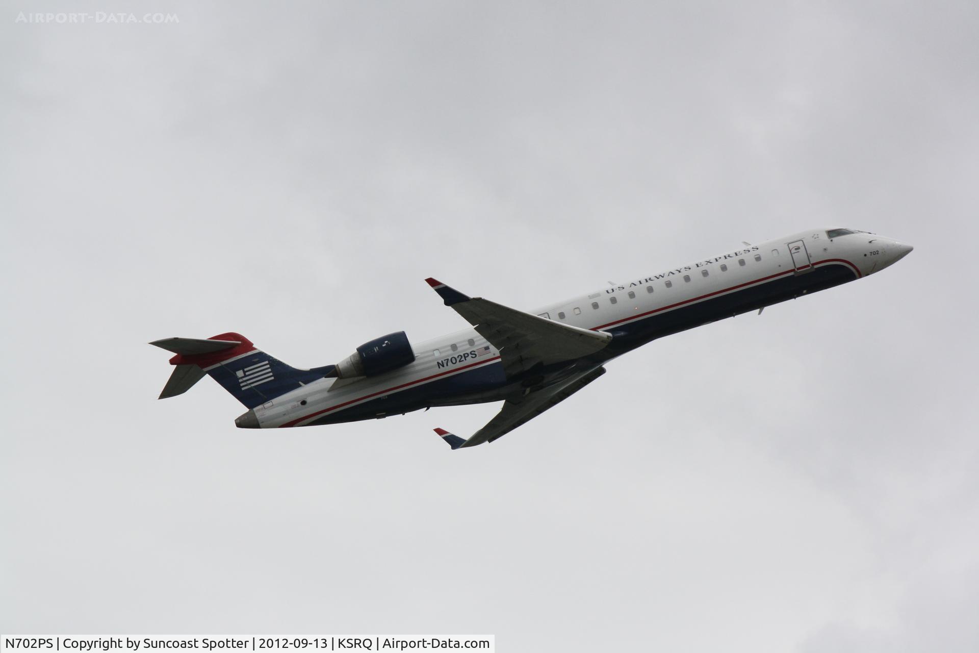 N702PS, 2004 Bombardier CRJ-701 (CL-600-2C10) Regional Jet C/N 10135, US Air Flight 2258 operated by PSA departs Sarasota-Bradenton International Airport enroute to Charlotte-Douglas International Airport