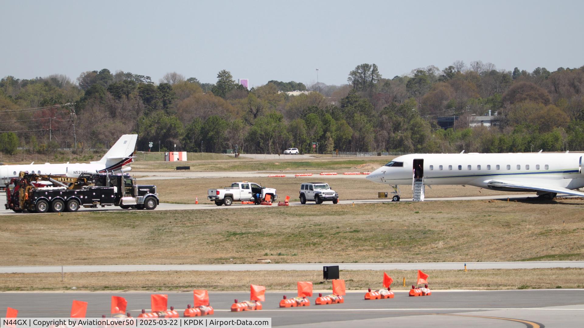 N44GX, 2004 Bombardier BD-700-1A10 Global Express C/N 9142, Global Express, with HUGE tow trucks preparing to hook up to the jet after the runway excursion the previous day
