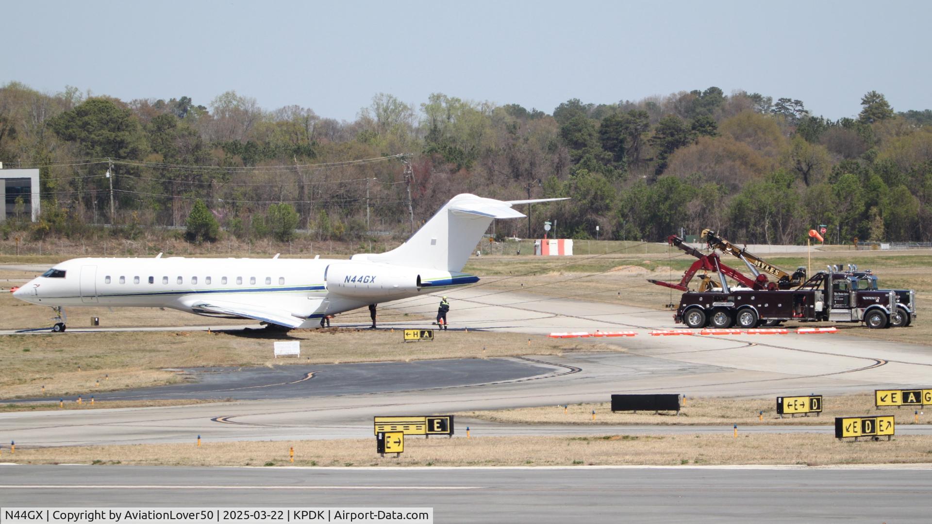 N44GX, 2004 Bombardier BD-700-1A10 Global Express C/N 9142, Global Express, with two tow trucks hooked up, attempting to remove the damaged jet from the grass after the runway excursion incident the previous day