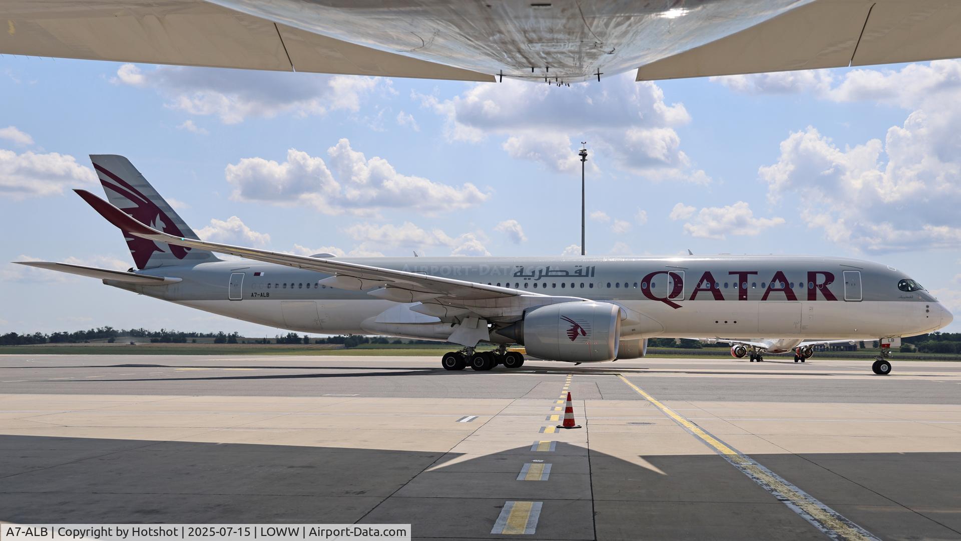A7-ALB, 2015 Airbus A350-941 C/N 007, Taxiing by parked UAE A380 and seen from underneath the big bird.