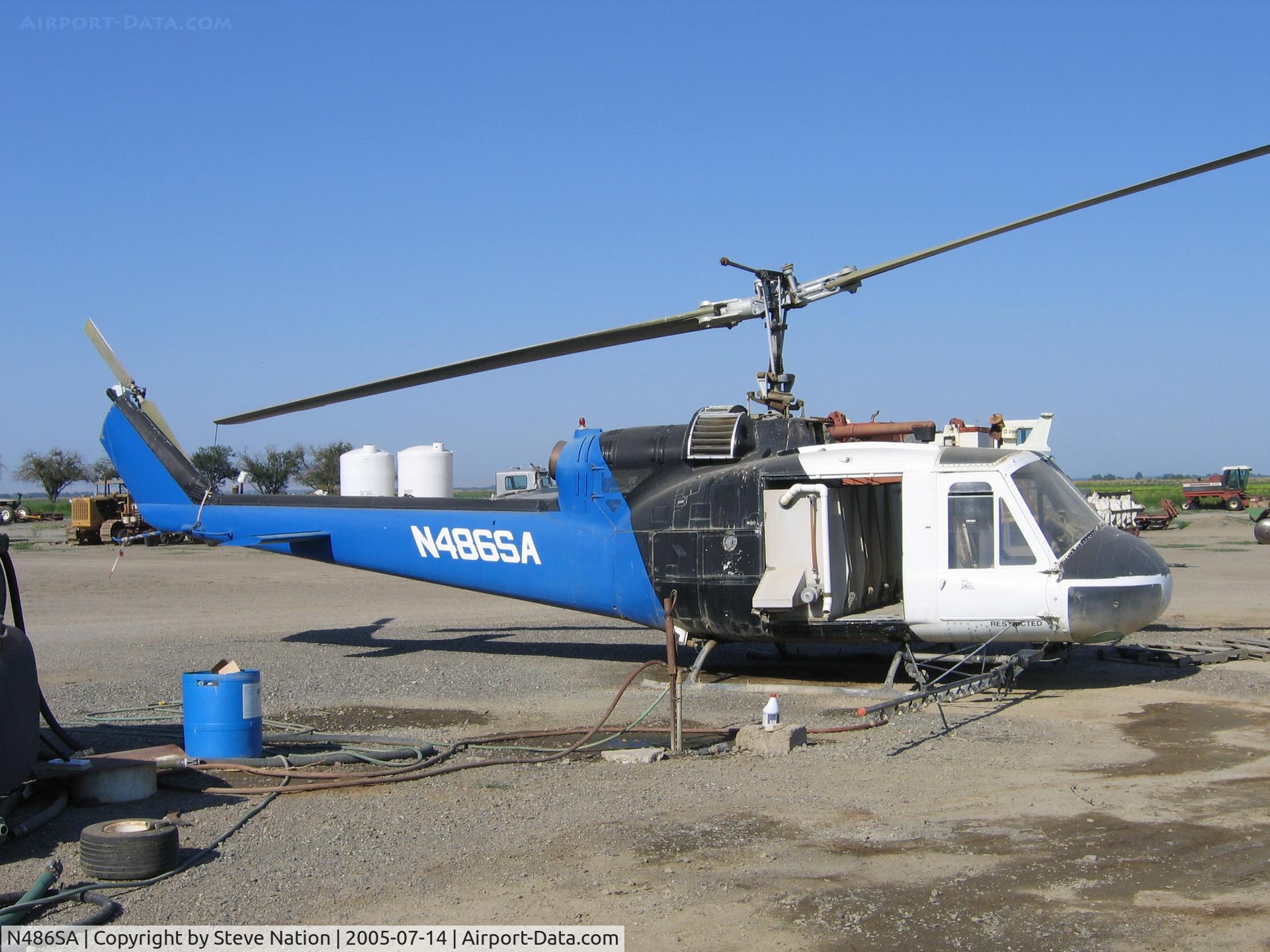 N486SA, 1962 Bell UH-1B C/N 62-4583, Peter Spyros' 1962 Bell UH-1B (62-4583) rigged as sprayer off Lone Star Rd in Arbuckle, CA