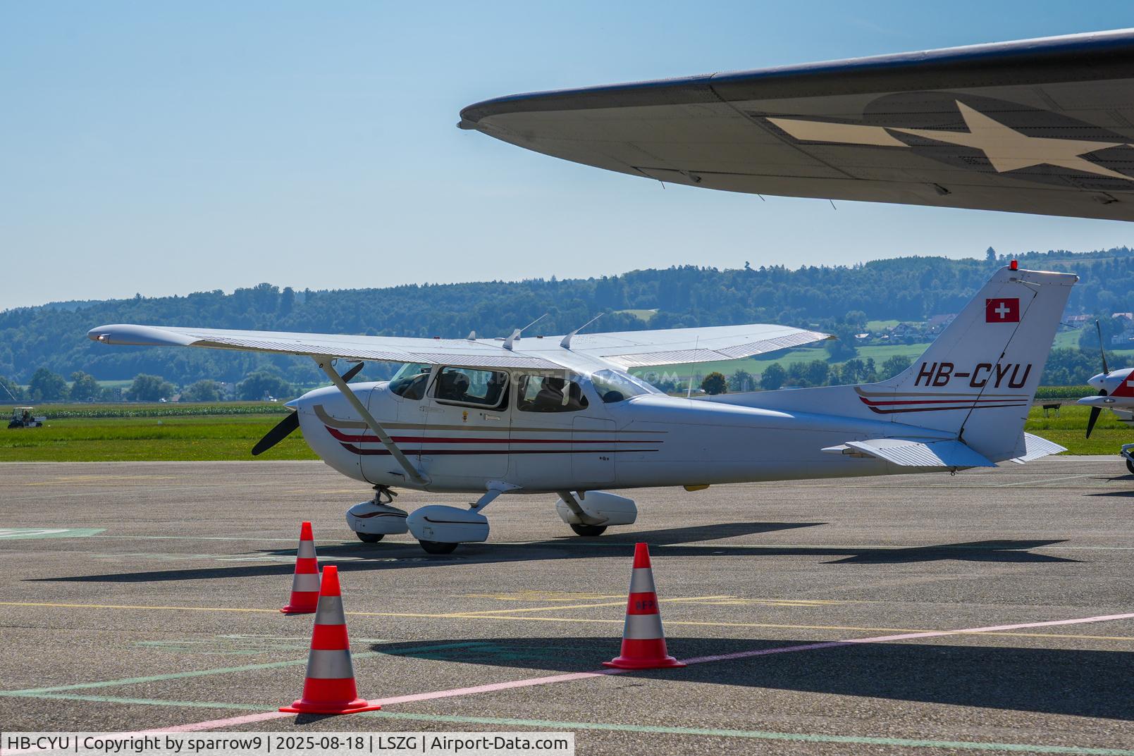 HB-CYU, 2003 Cessna 172S C/N 172S9323, Below the wing of a DC-3
