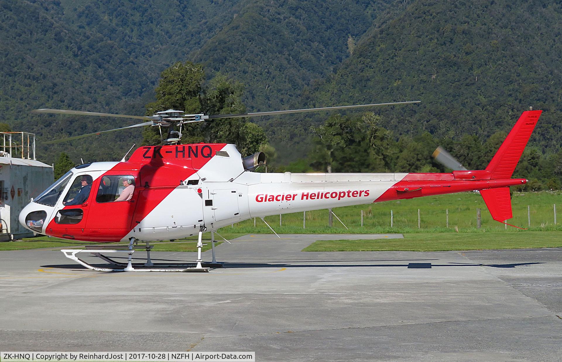 ZK-HNQ, Aerospatiale AS-350BA Ecureuil C/N 1972, ZK-HNQ of Glacier Helicopters about to take off with a load of tourists for a sightseeing-flight at Fox Heliport, South Island, New Zealand