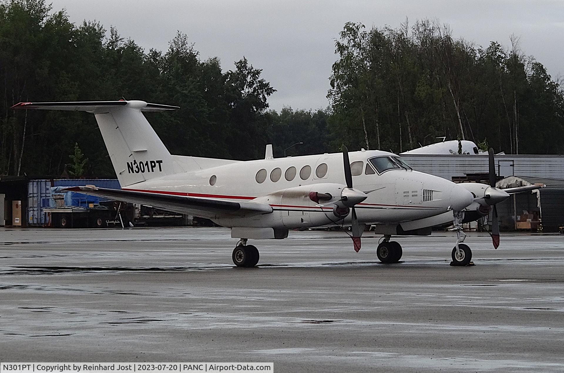 N301PT, 1983 Raytheon Aircraft Company A200CT C/N BP-028, Ex-USAF Huron N301PT at Anchorage, with a DC-3 in the background
