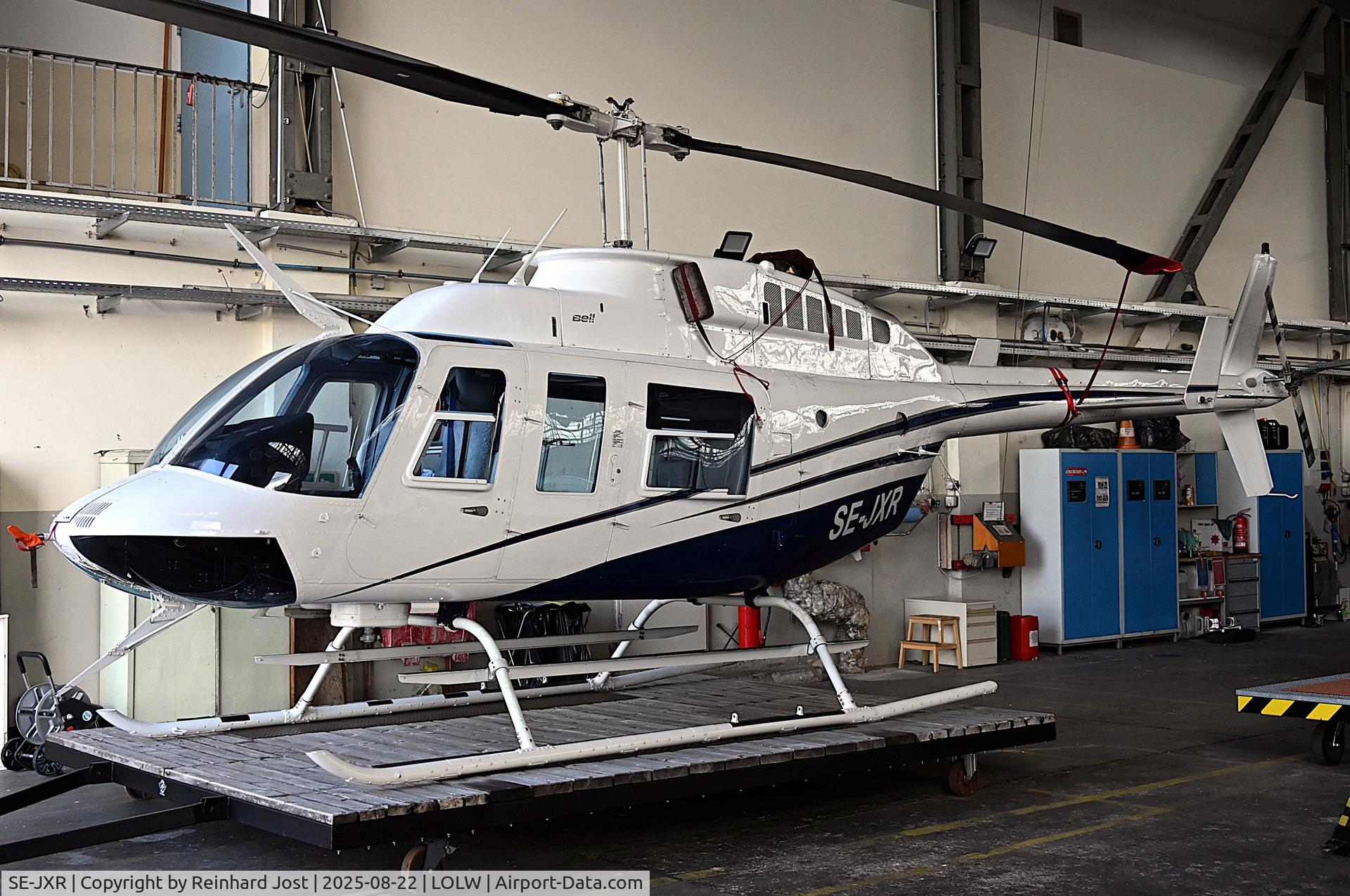 SE-JXR, 1980 Bell 206l-1 longRanger II LongRanger II C/N 45368, JetRanger II (ex-N1075T / N48ZP / N13UC /N18UG / G-CCUG / G-FANY / OY-HPI) on a moveable platform in the hangar at Wels Aerodrome, Austria