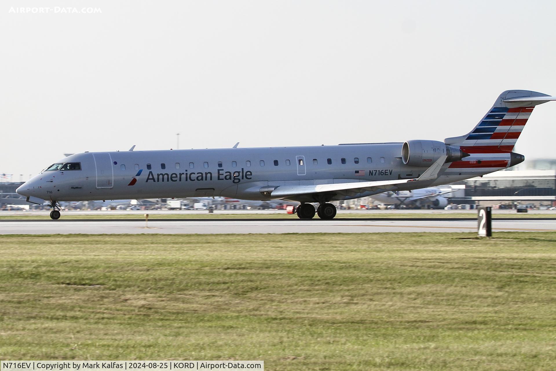 N716EV, 2003 Bombardier CRJ-701 (CL-600-2C10) Regional Jet C/N 10084, CRJ7 SkyWest / American Eagle Bombardier CRJ-701 N716EV Departing 22L KORD