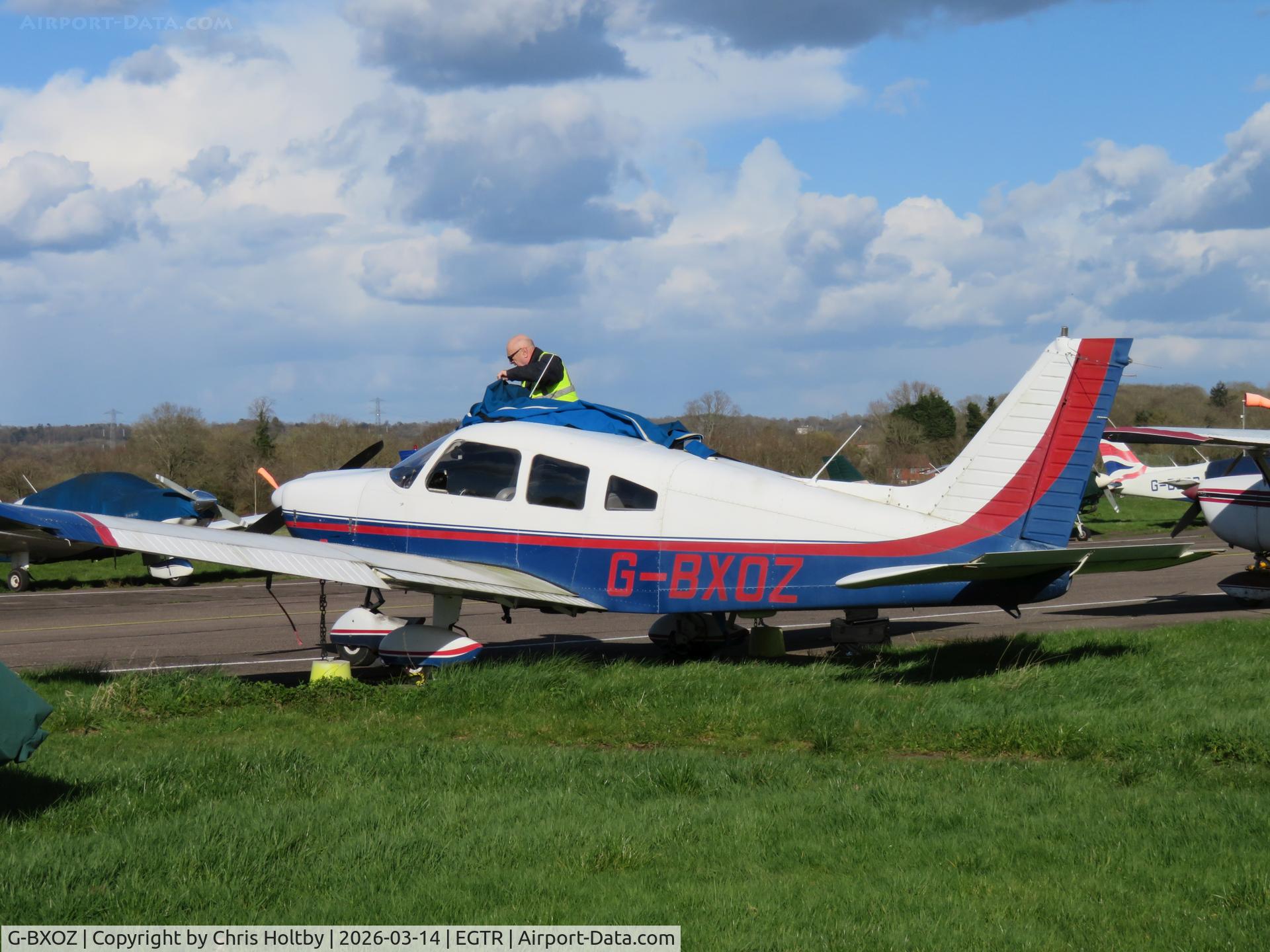 G-BXOZ, 1977 Piper PA-28-181 Cherokee Archer II C/N 28-7790173, Parked at Elstree, being covered