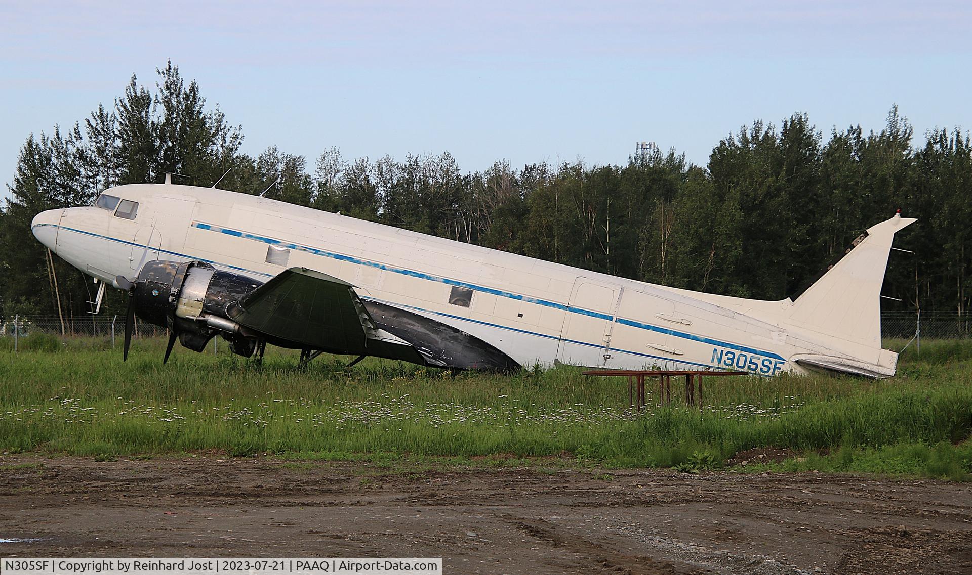 N305SF, 1944 Douglas DC-3C C/N 6208, DC-3C N305SF without vertical rudder in need of maintenance in a meadow close to Palmer Municipal, AK