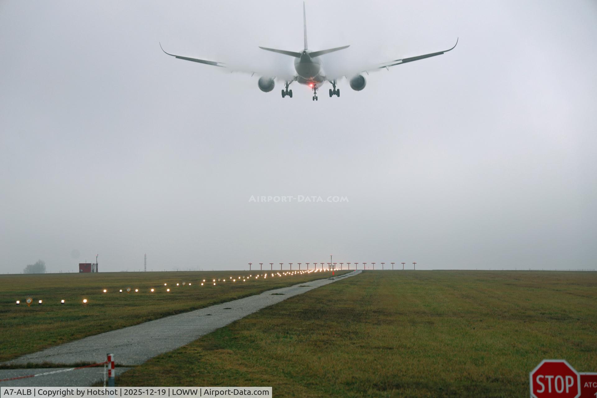 A7-ALB, 2015 Airbus A350-941 C/N 007, Visible lift creation with beacon flash above the approach lights in awful weather in December.