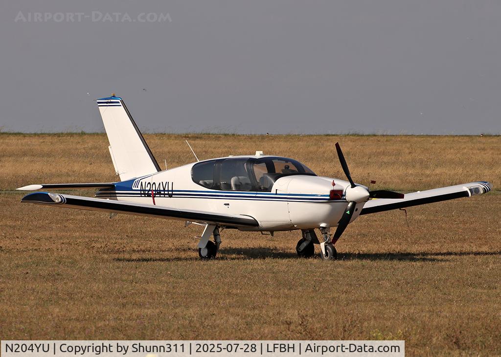 Aircraft N204YU, Socata TB-20 Trinidad, c/n 910, Parked in the grass... New c/s..., at LFBH, photo by Shunn311
