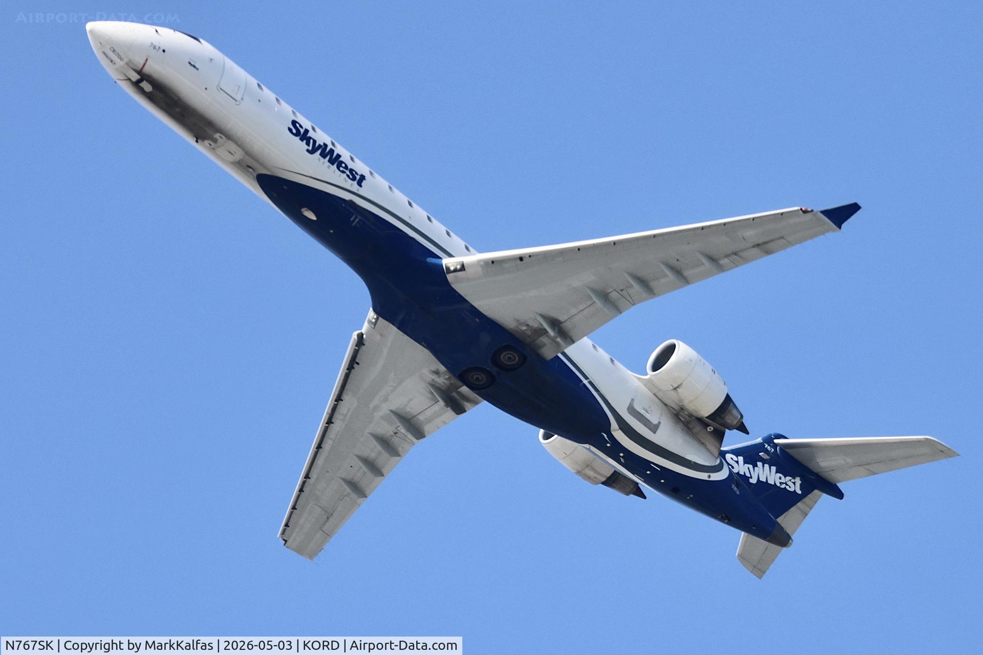 Aircraft N767SK, 2005 Bombardier CRJ-702 (CL-600-2C10) Regional Jet, c/n 10233, CRJ7 SkyWest / United Express Bombardier CRJ-702 N767SK departing 28R KORD, at KORD, photo by MarkKalfas