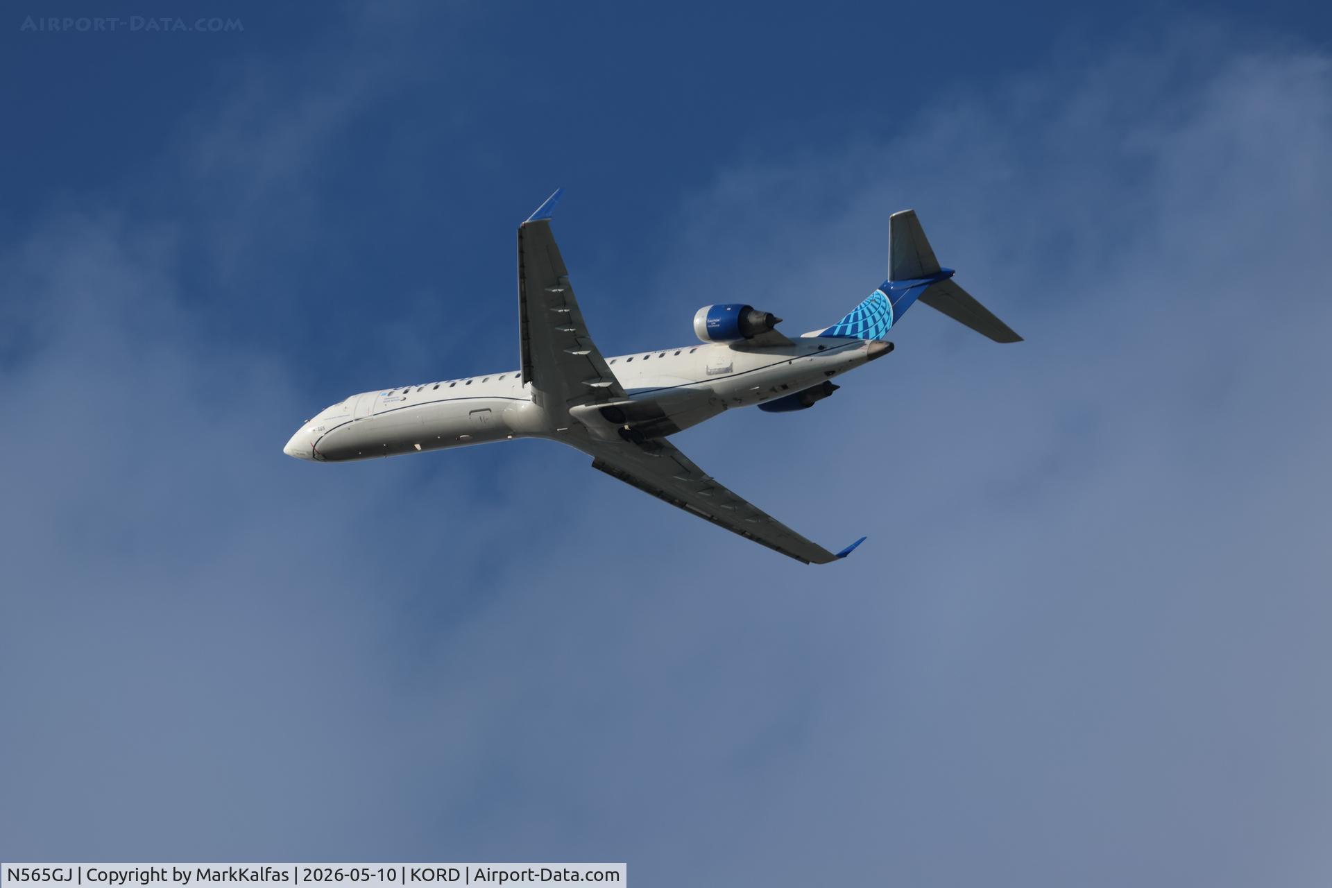 Aircraft N565GJ, 2003 Bombardier CRJ-700 (CL-600-2C10) Regional Jet, c/n 10087, CRJ7 GoJet/United Express Bombardier CRJ 550, N565GJ departing 28R KORD, at KORD, photo by MarkKalfas