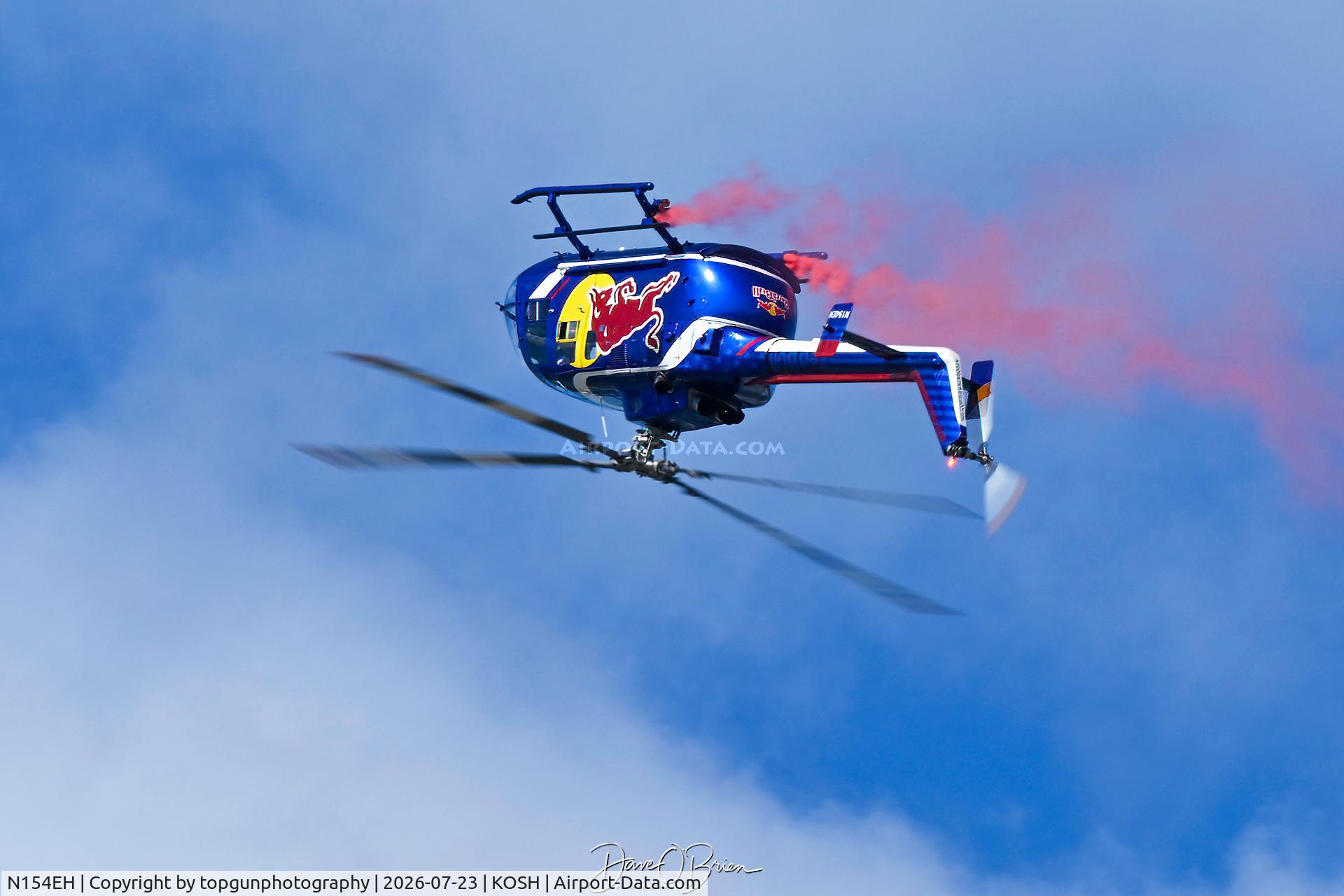 Aircraft N154EH, 1985 MBB Bo-105CBS-4, c/n S-704, Red Bull helo over the top, at KOSH, photo by topgunphotography