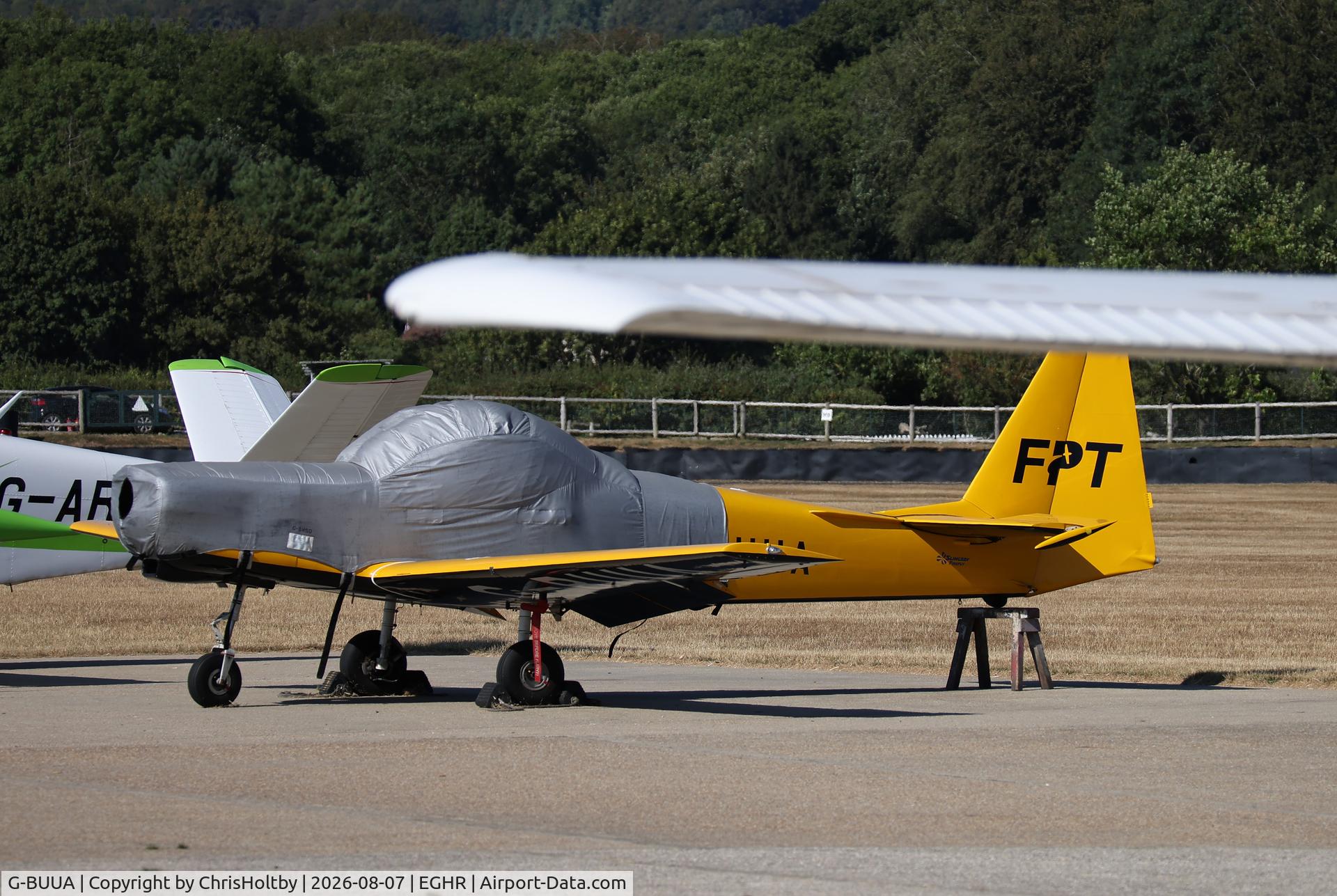 Aircraft G-BUUA, 1993 Slingsby T-67M Firefly Mk2, c/n 2111, Parked and covered at Goodwood. Prop removed., at EGHR, photo by ChrisHoltby