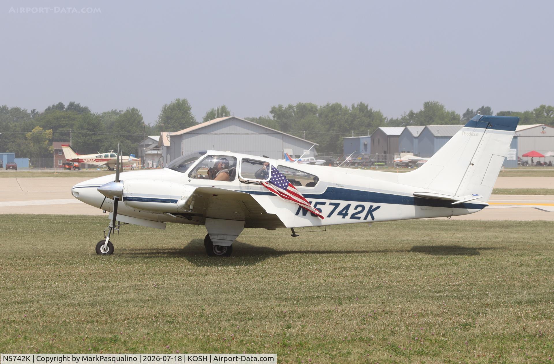 Aircraft N5742K, 1964 Beech 95-B55 Baron, c/n TC-729, Beech B55, at KOSH, photo by MarkPasqualino