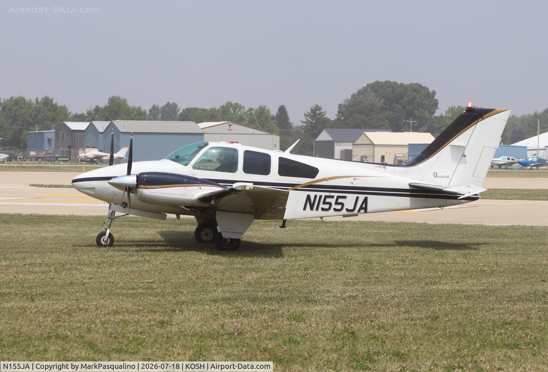Aircraft N155JA, 1976 Beech 95-B55 (T42A) Baron, c/n TC-1993, Beech B55, at KOSH, photo by MarkPasqualino