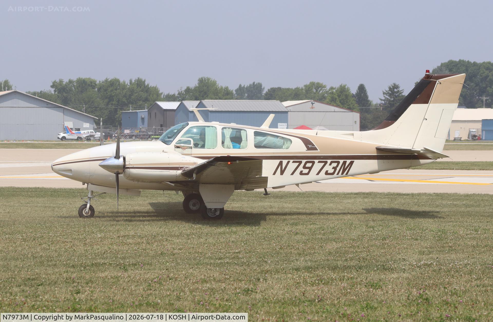 Aircraft N7973M, 1966 Beech C55 Baron (95-C55), c/n TE-208, Beech C55, at KOSH, photo by MarkPasqualino