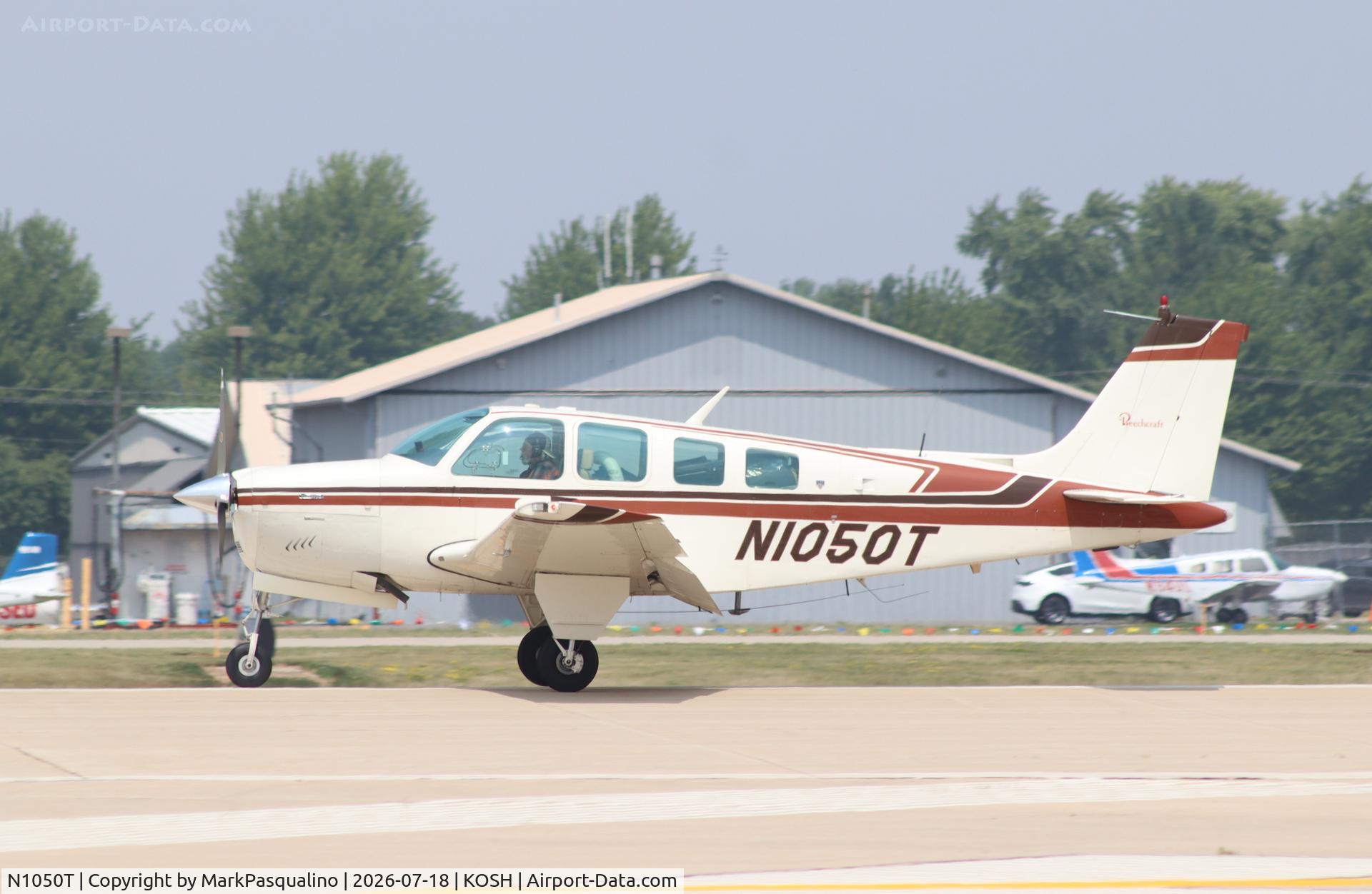 Aircraft N1050T, 1976 Beech A36 Bonanza 36, c/n E-881, Beech A36, at KOSH, photo by MarkPasqualino
