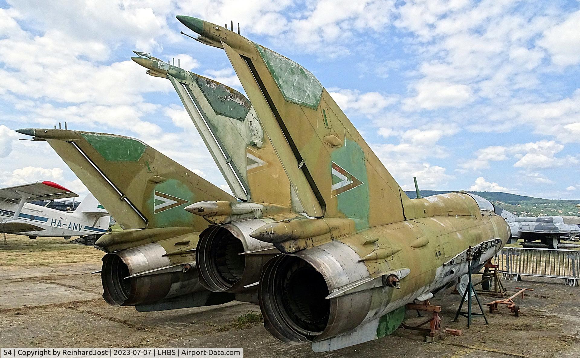 Aircraft 54, Mikoyan-Gurevich MiG-21UM, c/n 516999299, 54 is one of a several MiG-21 wrecks at a private collection at the old Budapest Airport at Budaörs, Hungary, at LHBS, photo by ReinhardJost