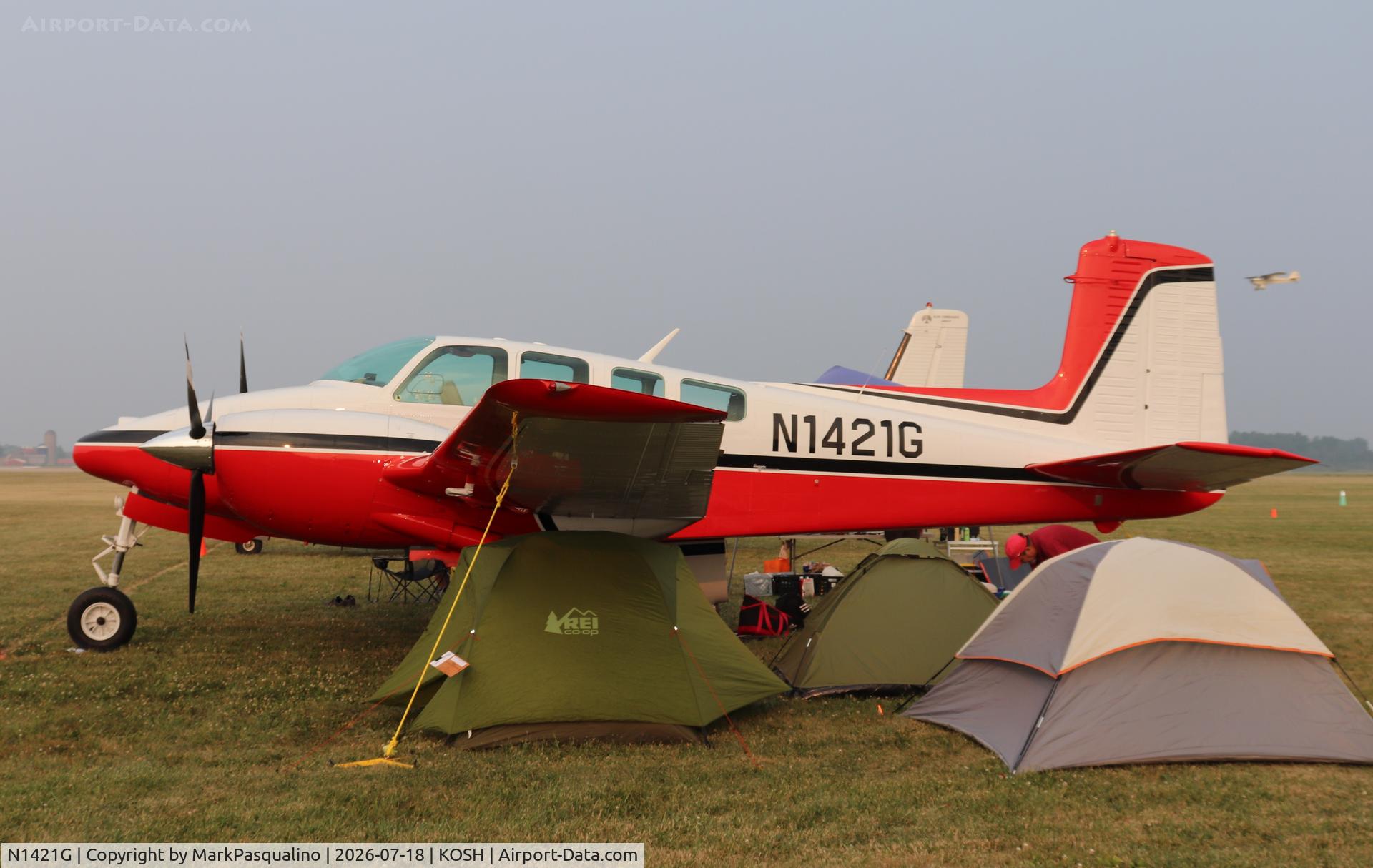 Aircraft N1421G, 1962 Beech D50E Twin Bonanza, c/n DH-333, Beech D50E, at KOSH, photo by MarkPasqualino