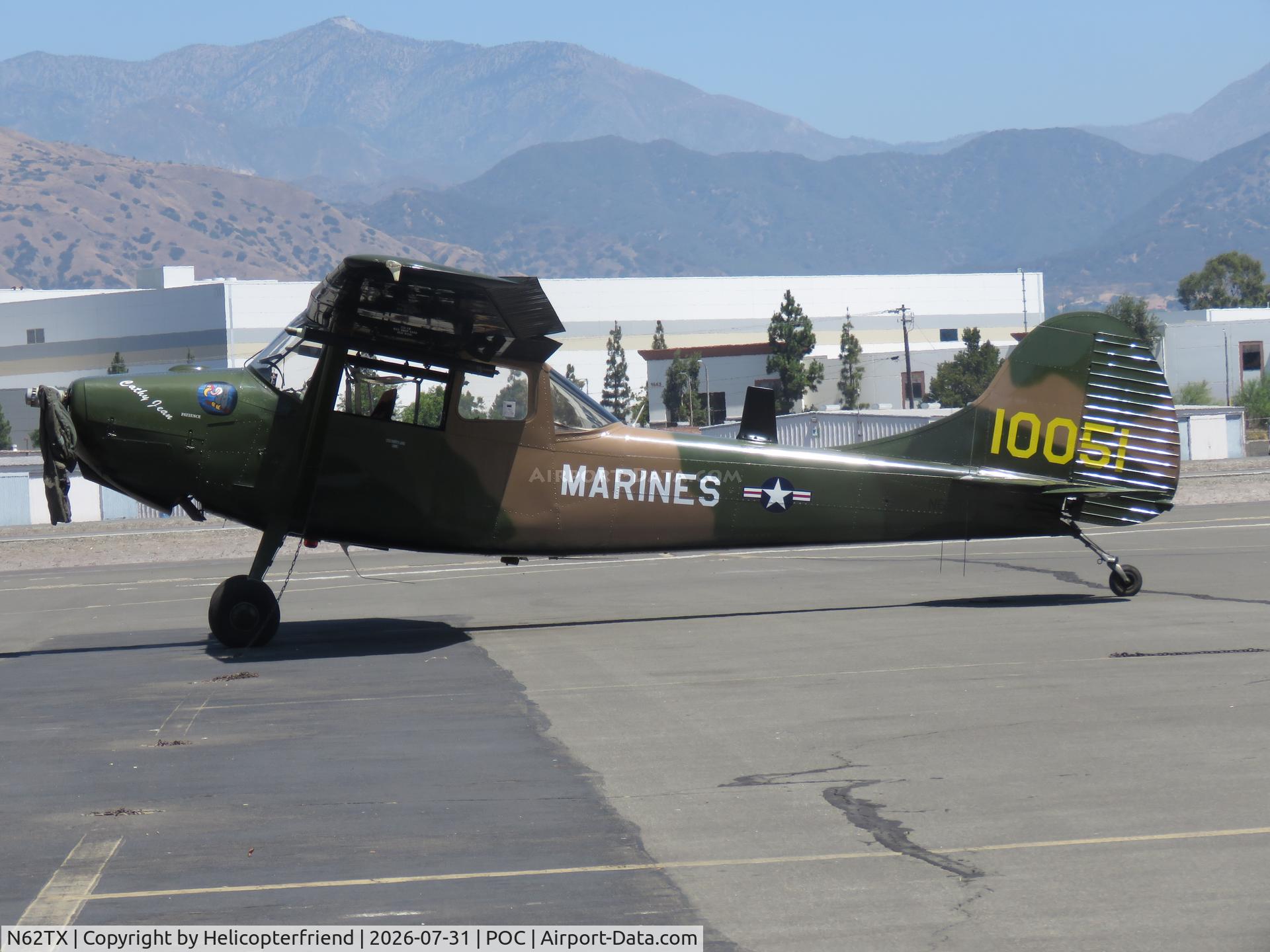 Aircraft N62TX, 1963 Cessna 305C (O-1E) Bird Dog, c/n 305M-0051, Parked with flight suit resting on prop, at POC, photo by Helicopterfriend