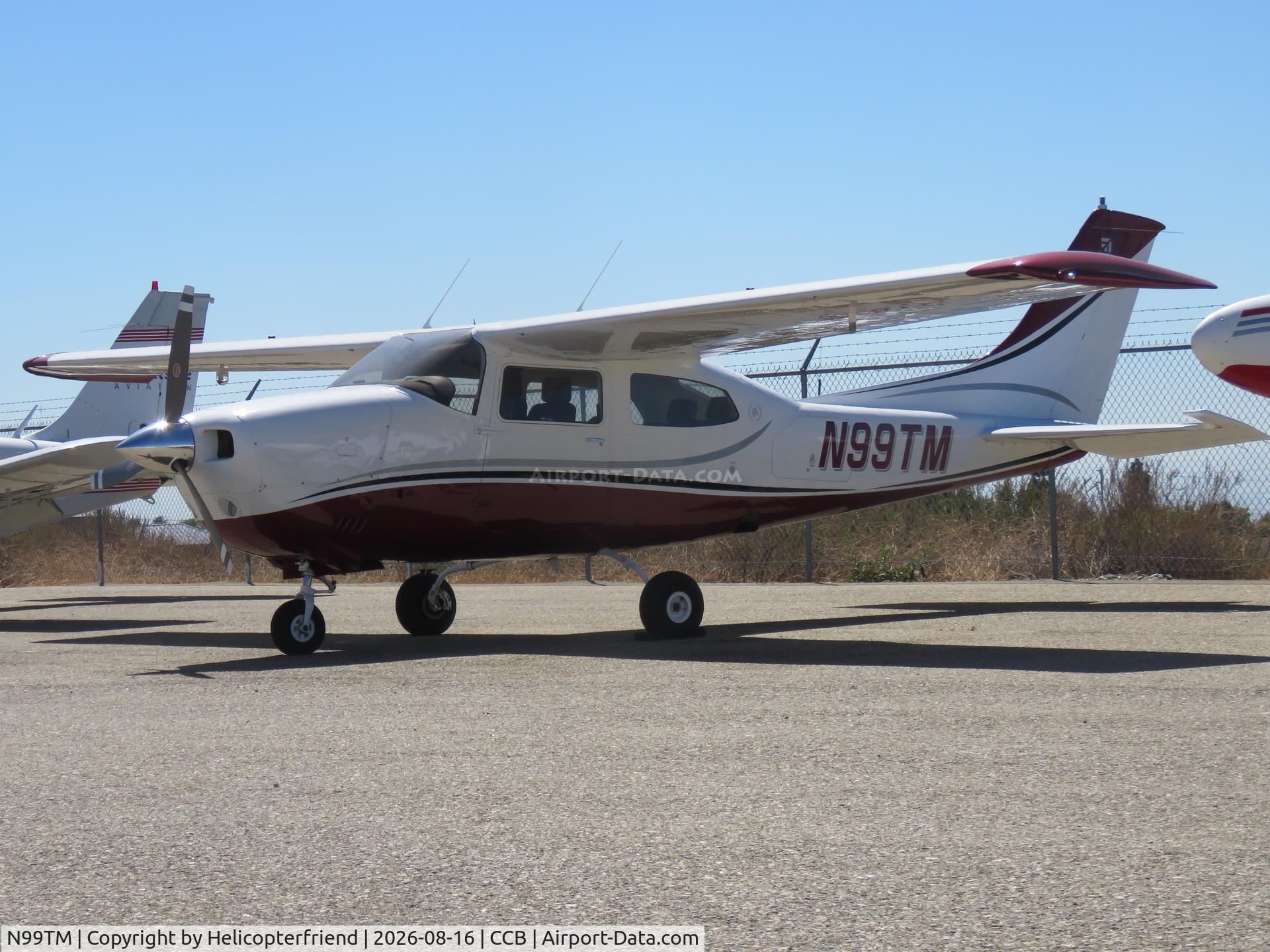 Aircraft N99TM, 1977 Cessna 210M Centurion, c/n 21061712, Parked by the south fence, at CCB, photo by Helicopterfriend