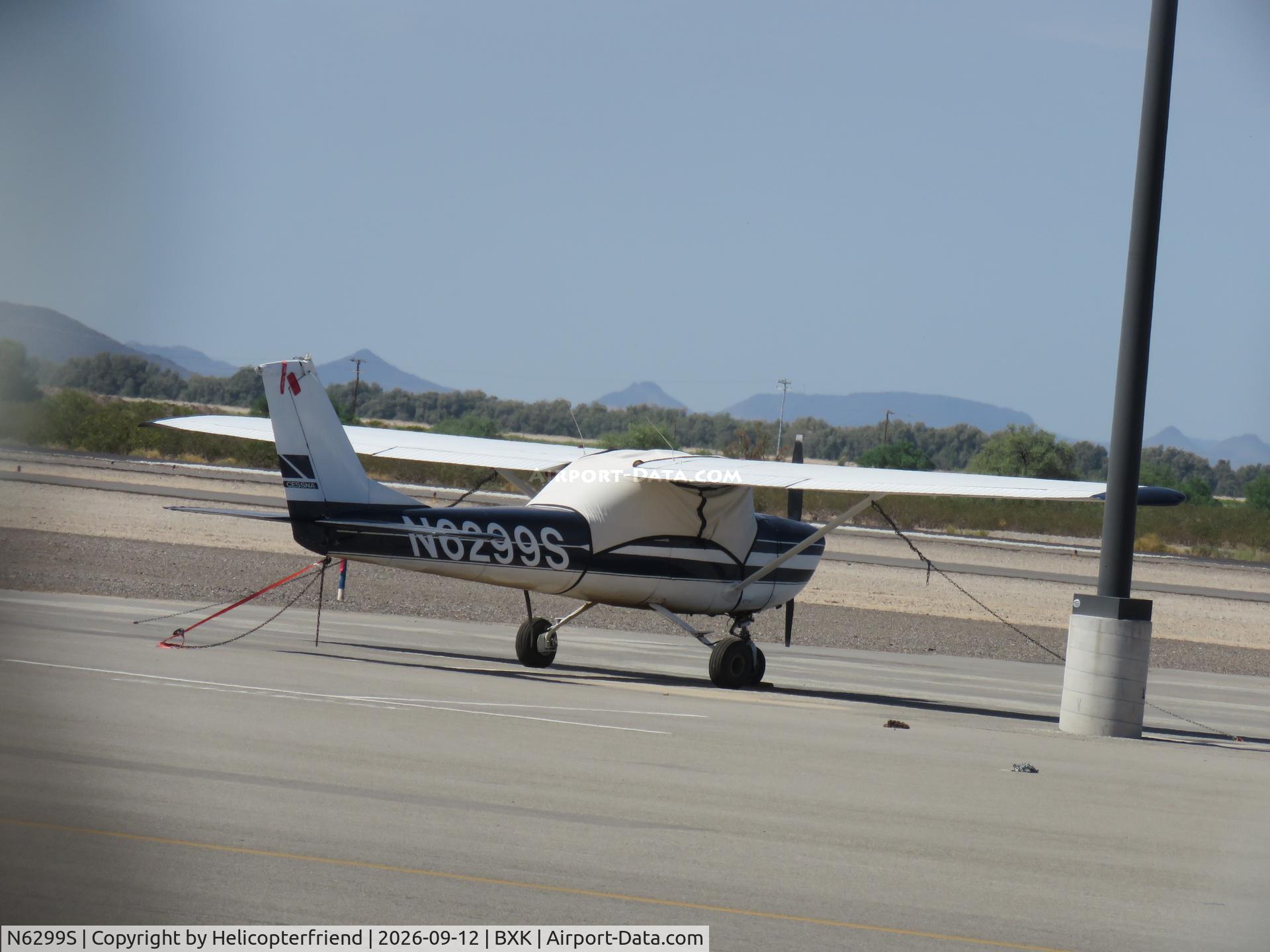 Aircraft N6299S, 1967 Cessna 150G, c/n 15067099, Covered and tied down, at BXK, photo by Helicopterfriend