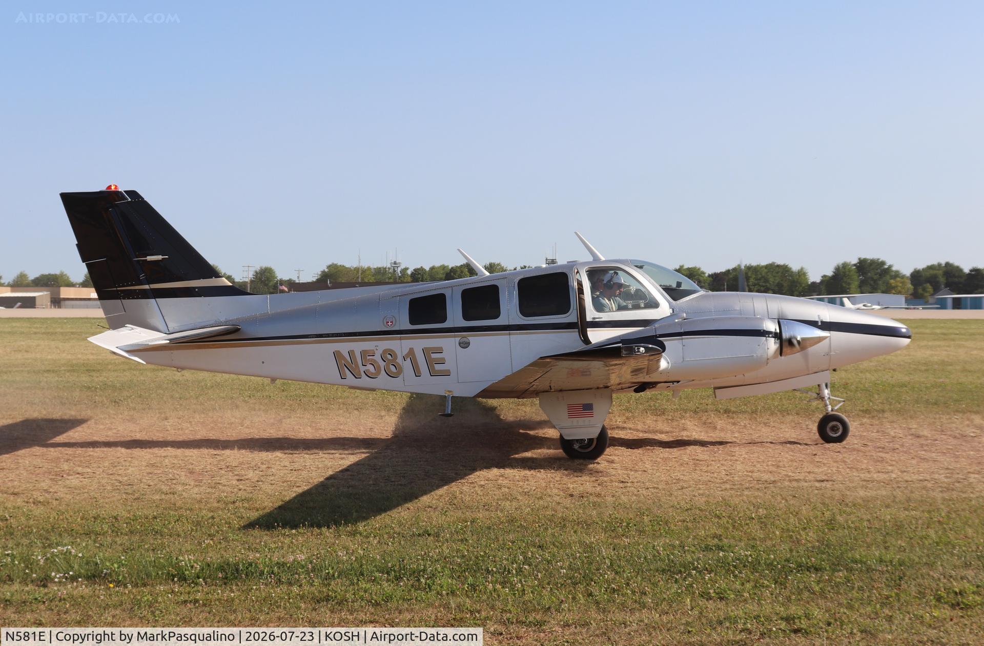 Aircraft N581E, 1973 Beech 58 Baron, c/n TH-423, Beech 58, at KOSH, photo by MarkPasqualino