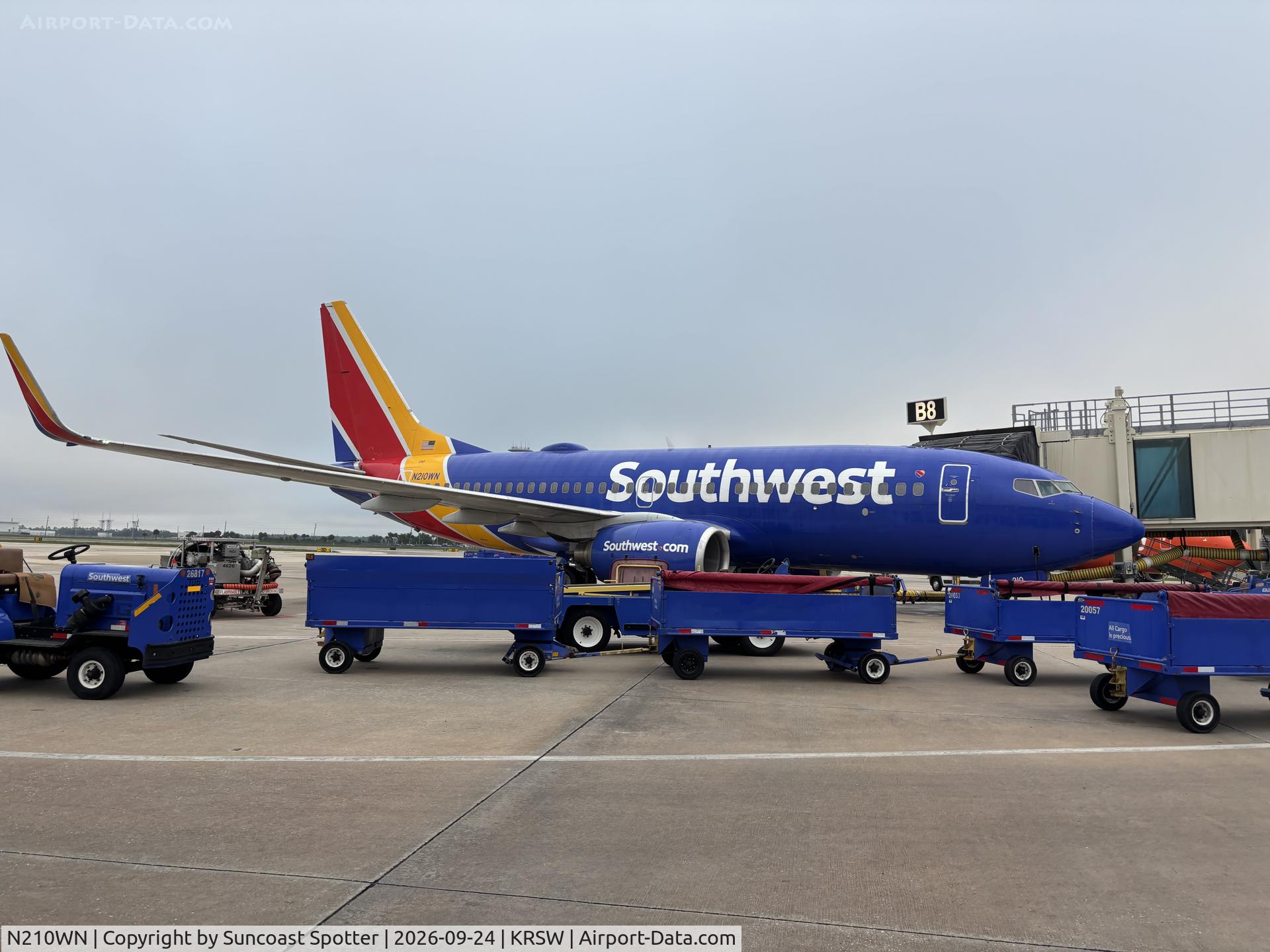 Aircraft N210WN, 2005 Boeing 737-7H4, c/n 34162, Boeing 737 sits at the gate at RSW, at KRSW, photo by Suncoast Spotter