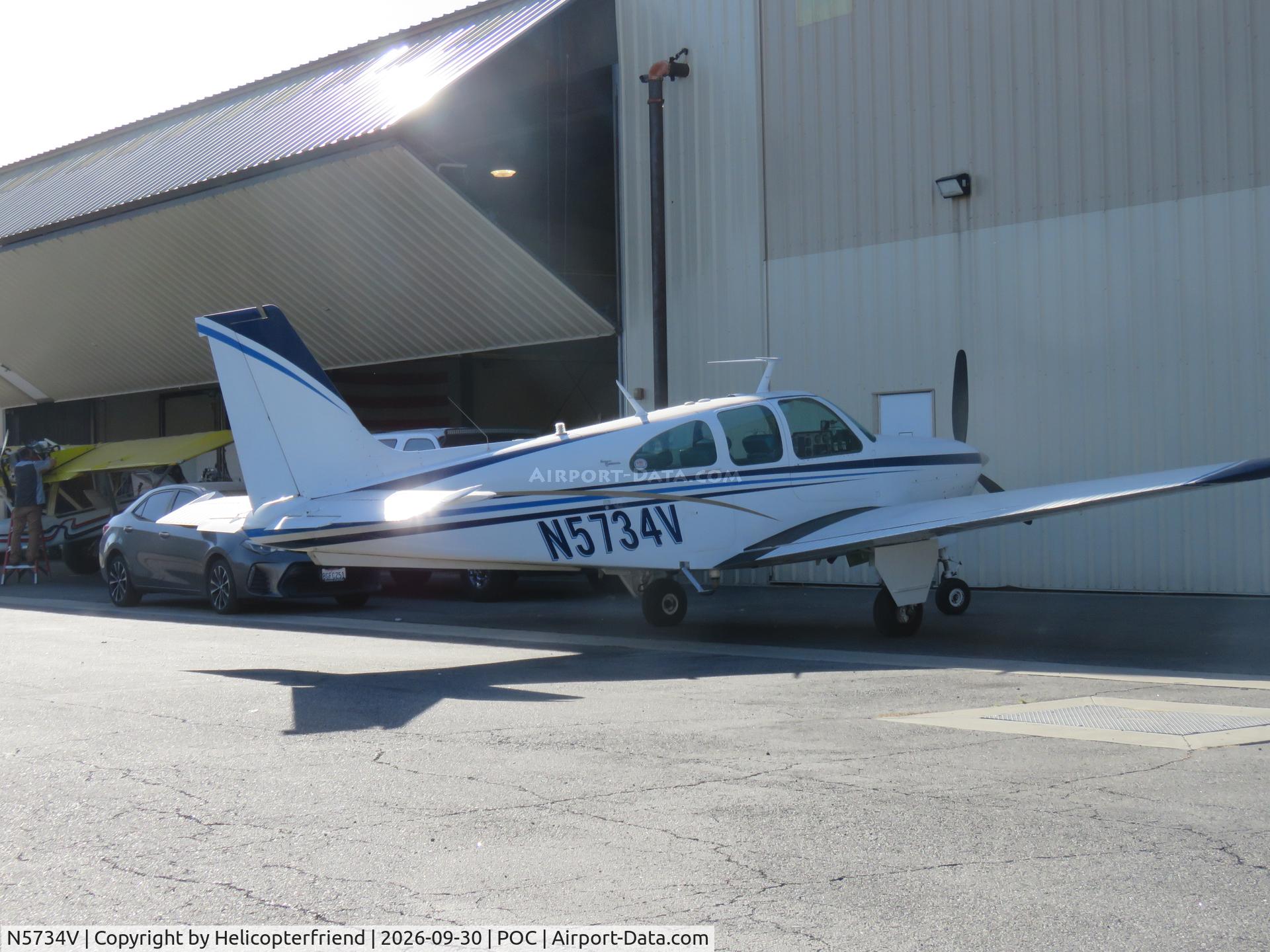 Aircraft N5734V, 1966 Beech 35-C33A Debonair, c/n CE-28, Parked by a hanger, at POC, photo by Helicopterfriend