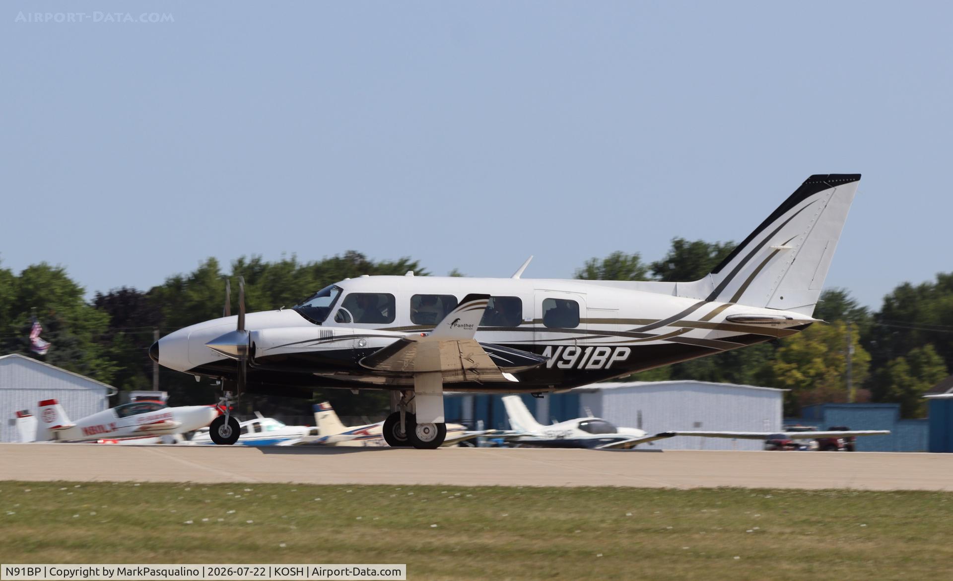 Aircraft N91BP, 1977 Piper PA-31-325 Navajo C/R, c/n 31-7812034, Piper PA-31-325, at KOSH, photo by MarkPasqualino