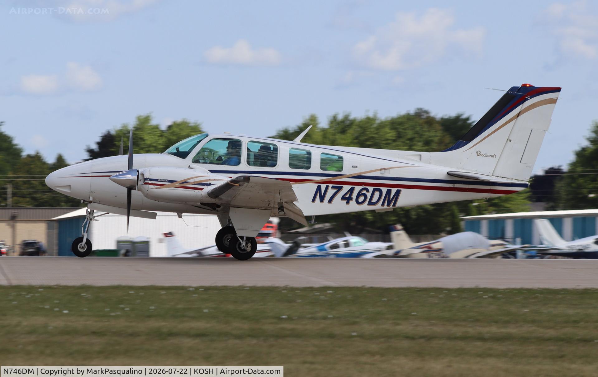 Aircraft N746DM, 1973 Beech 58 Baron, c/n TH-354, Beech 58, at KOSH, photo by MarkPasqualino