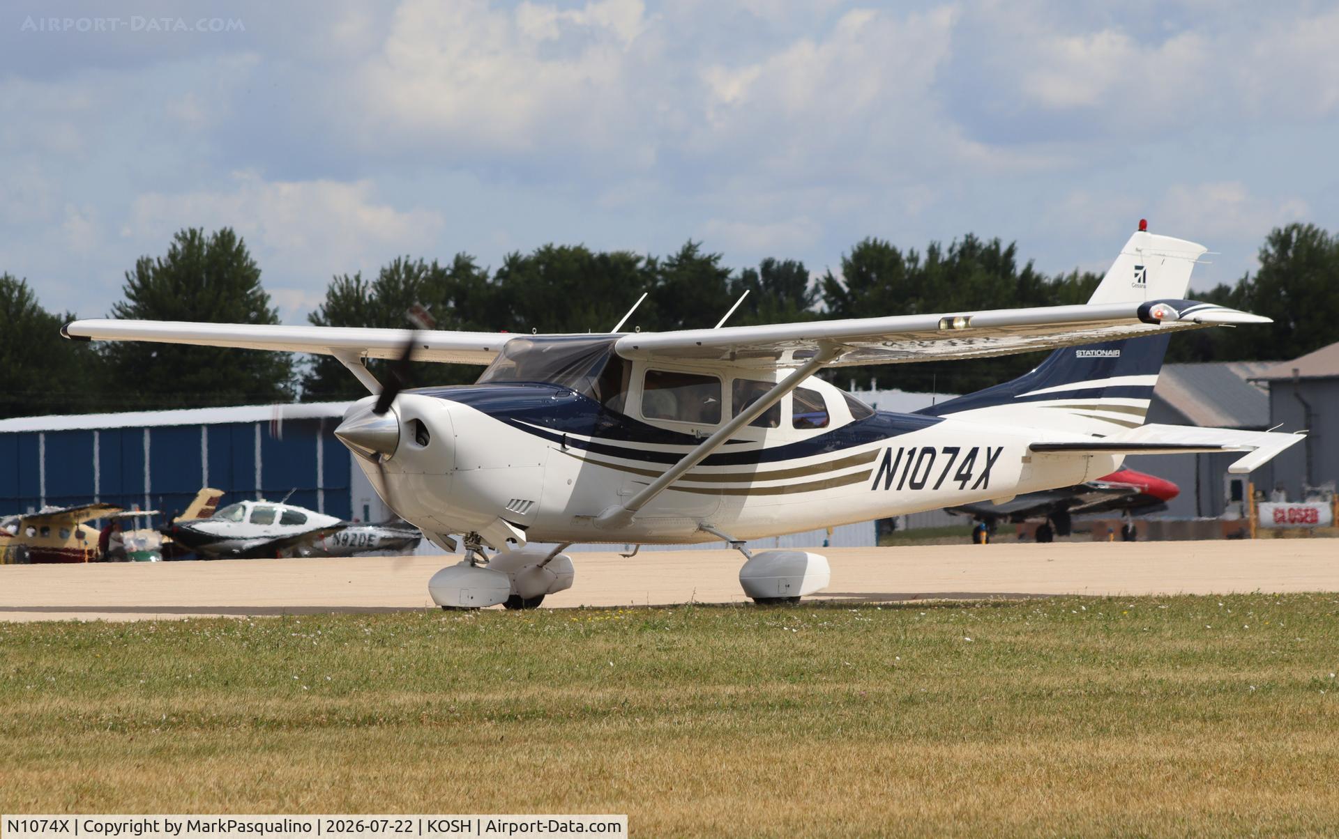Aircraft N1074X, 2005 Cessna 206H Stationair, c/n 20608233, Cessna 206H, at KOSH, photo by MarkPasqualino