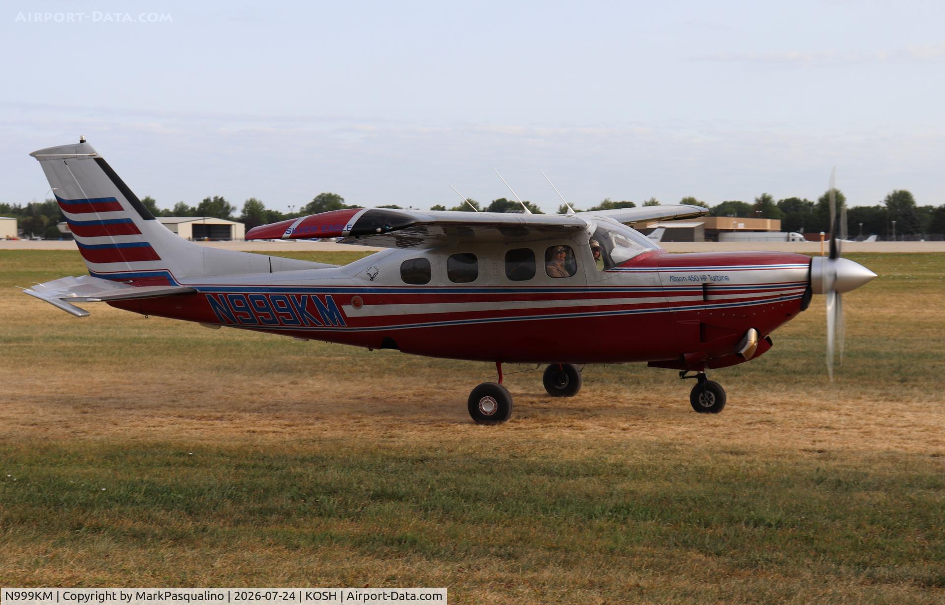 Aircraft N999KM, 1979 Cessna P210N Pressurised Centurion, c/n P21000387, Cessna P210N, at KOSH, photo by MarkPasqualino