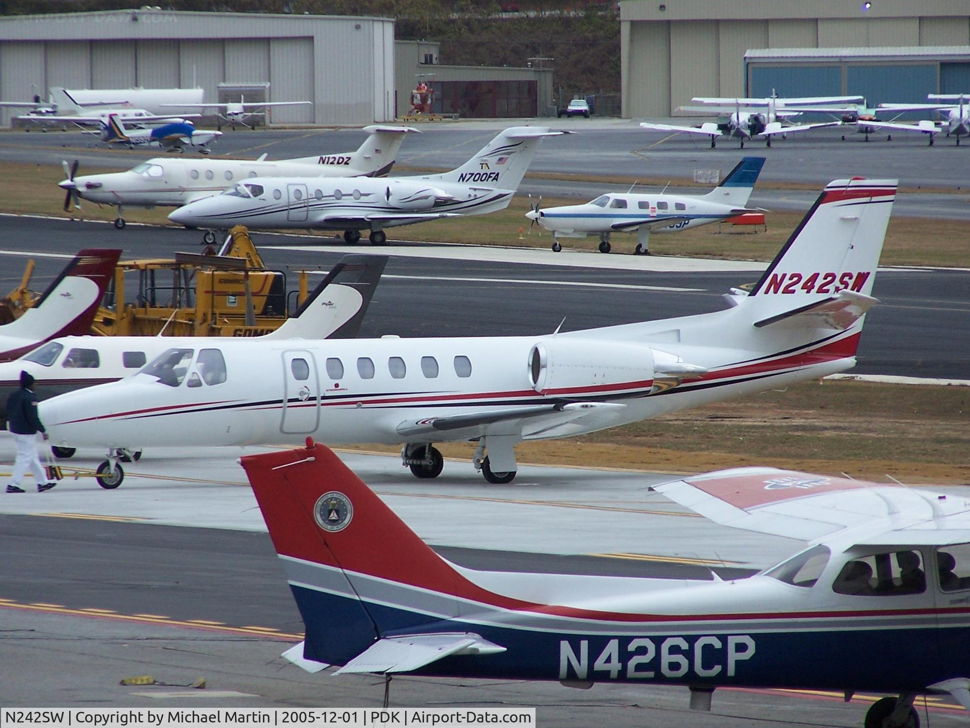 N242SW, 1999 Cessna 550 C/N 550-0908, Tied down @ PDK with vairous AC in background