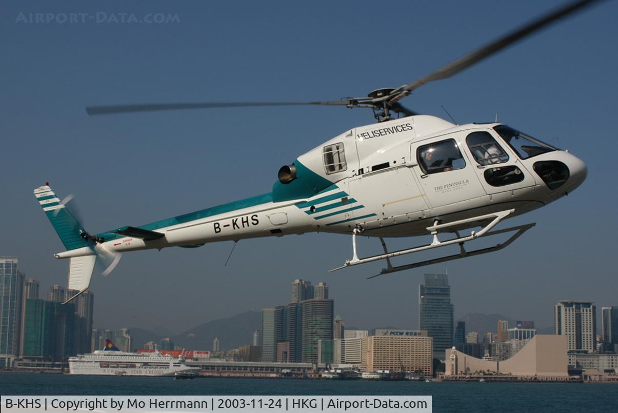 B-KHS, Aerospatiale AS-355N Ecureuil 2 C/N 5718, Heliservices of Hong Kong after lift-off at Queen Victoria Business District Heliport. Background Kowloon with Star Ferry Terminal
