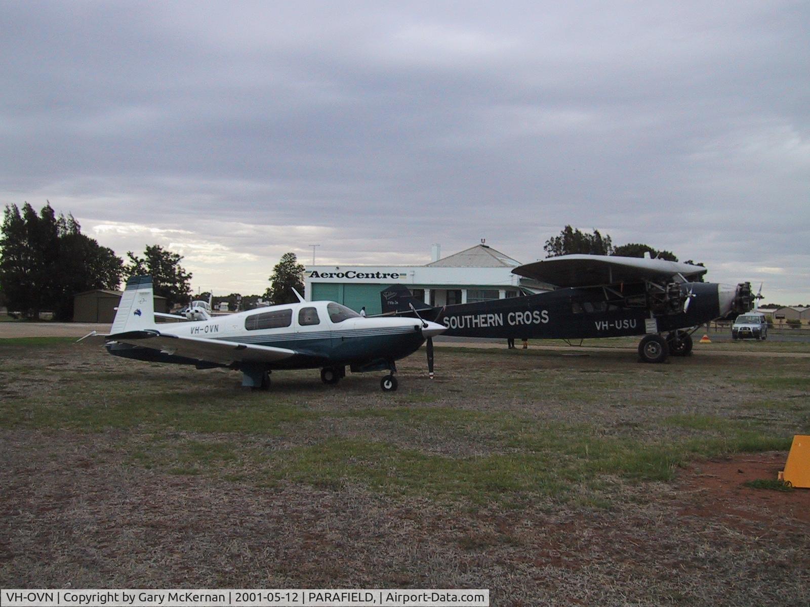 VH-OVN, 1998 Mooney M20R Ovation C/N 29-0156, Ovation with VH-USU Southern Cross Replica in background
