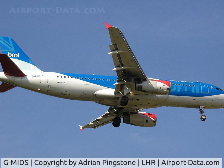G-MIDS, 2001 Airbus A320-232 C/N 1424, The swept wing of a British Midland Airbus A320-200 (G-MIDS). The aircraft is landing at London (Heathrow) Airport. 2002