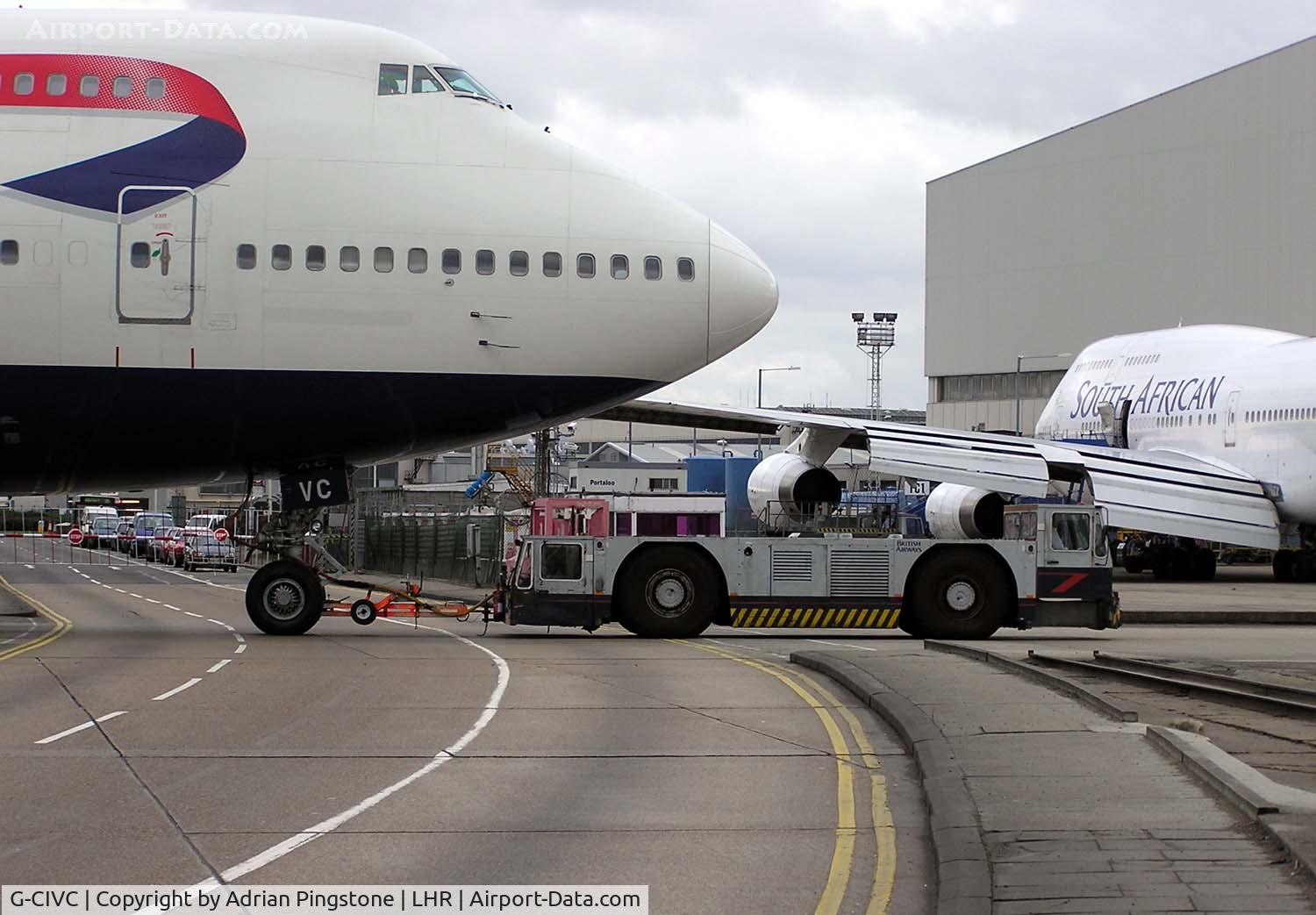 G-CIVC, 1994 Boeing 747-436 C/N 25812, A ground-handling tug pulls a British Airways Boeing 747-400 (G-CIVC) across a public road at London (Heathrow) Airport, England in January 2005