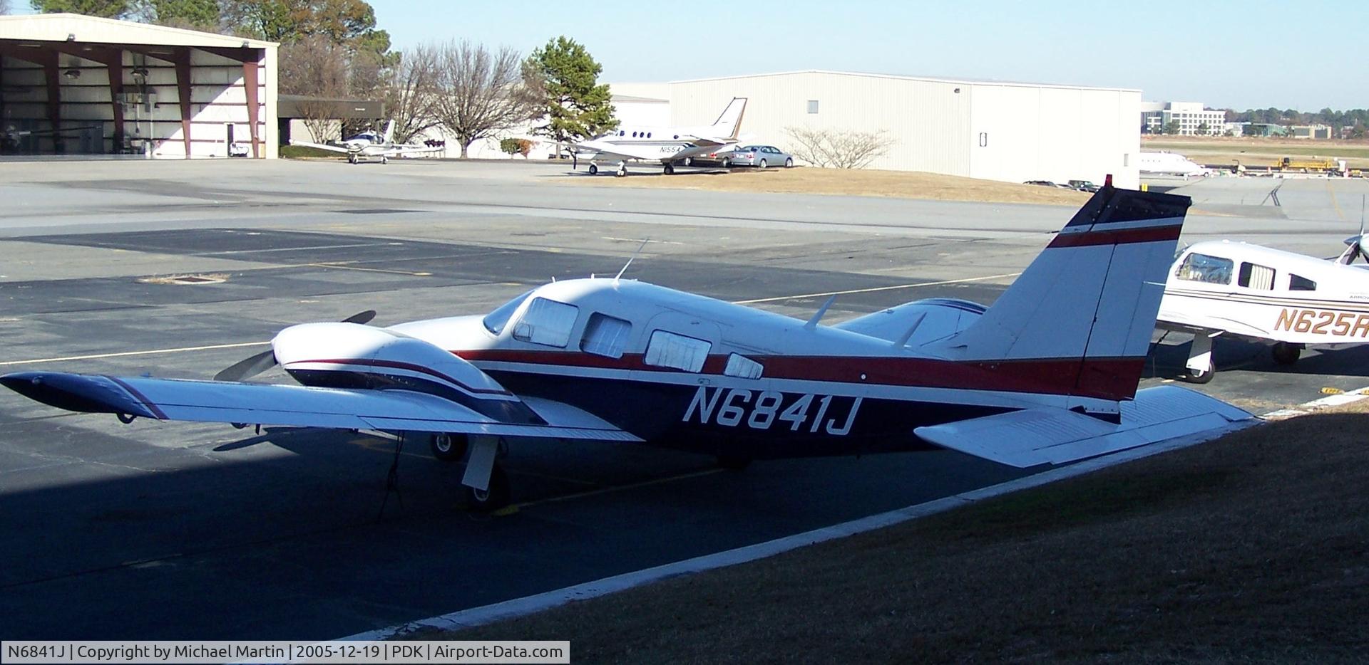 N6841J, 1976 Piper PA-34-200T C/N 34-7670283, Tied down @ PDK with vairous AC in background